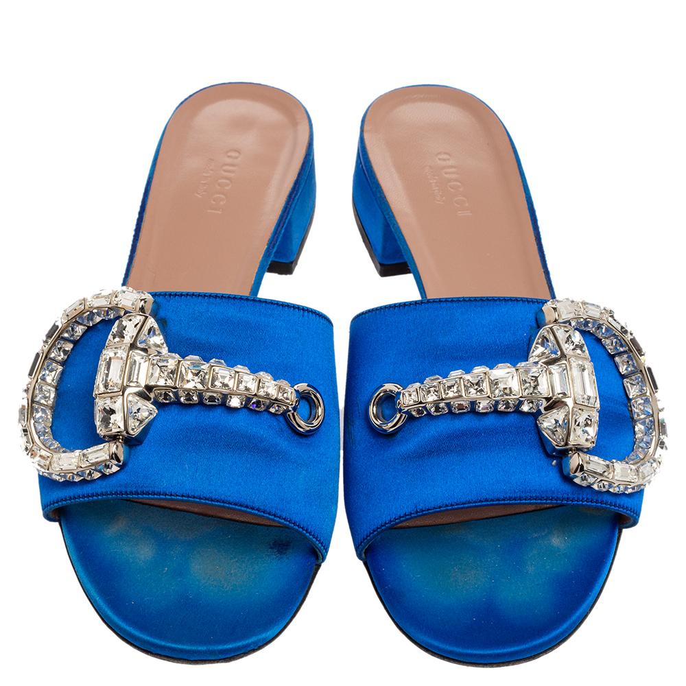 Glam it up with Gucci's royal blue Maxime slides! Made from satin, they feature signature bit details embellished with crystals on the vamps. They have leather lining, padded insoles, and short block heels.

Includes: Original Dustbag
