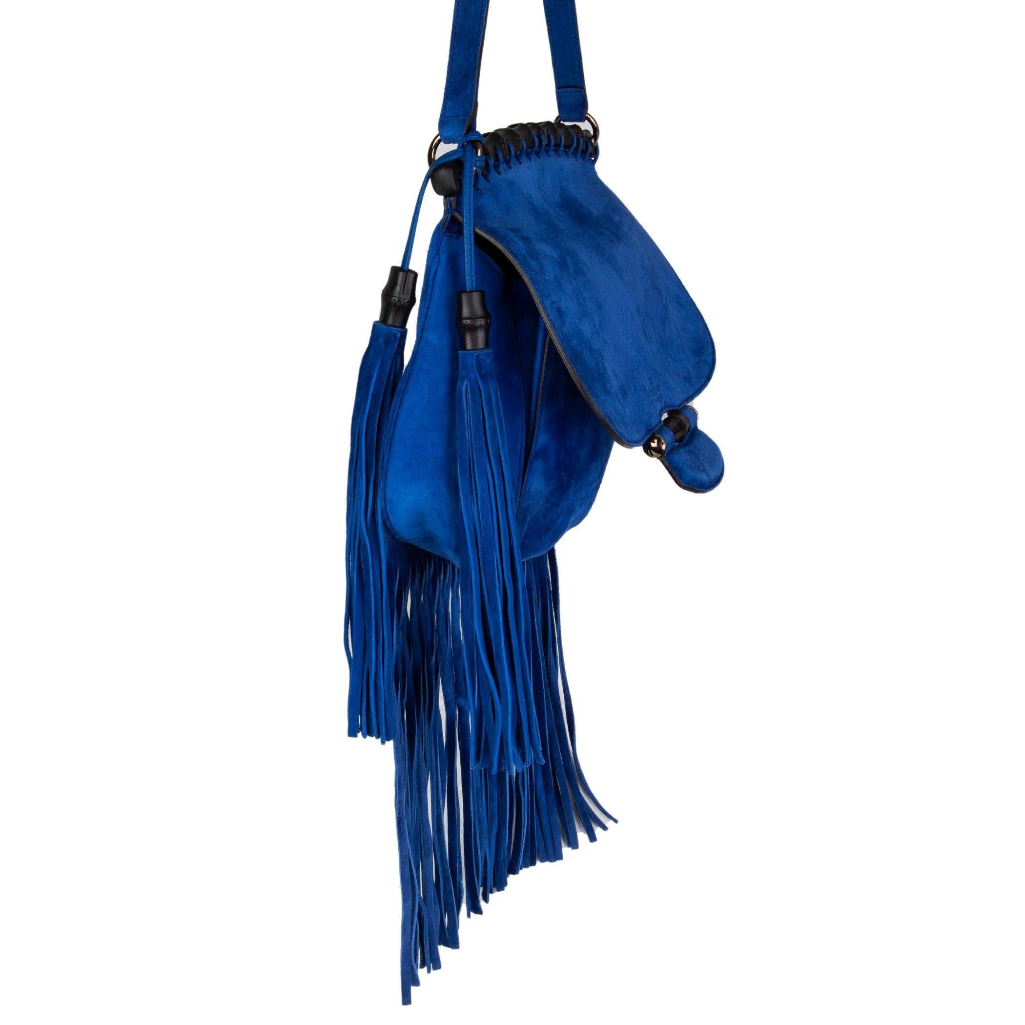 Gucci fringed flap bag in royal-blue suede featuring black bamboo details on the flap and on top part. Lined in blue and tan calfskin with one zip pocket against the back and a button pocket on top. Has been carried and is in excellent condition.