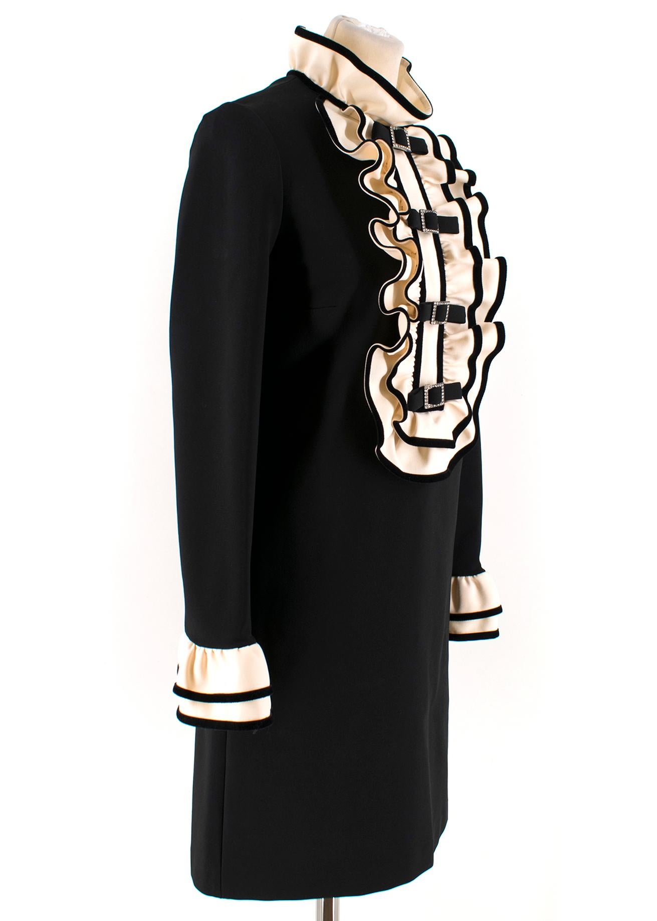 Gucci ruffle-bib black dress

- Black, heavyweight stretch fabric 
- High neck, long sleeves 
- Cream ruffle neck, tiered ruffle cuffs and front bib feature, black velvet-trimmed edges 
- Four front decorative black bows, clear crystal embellished