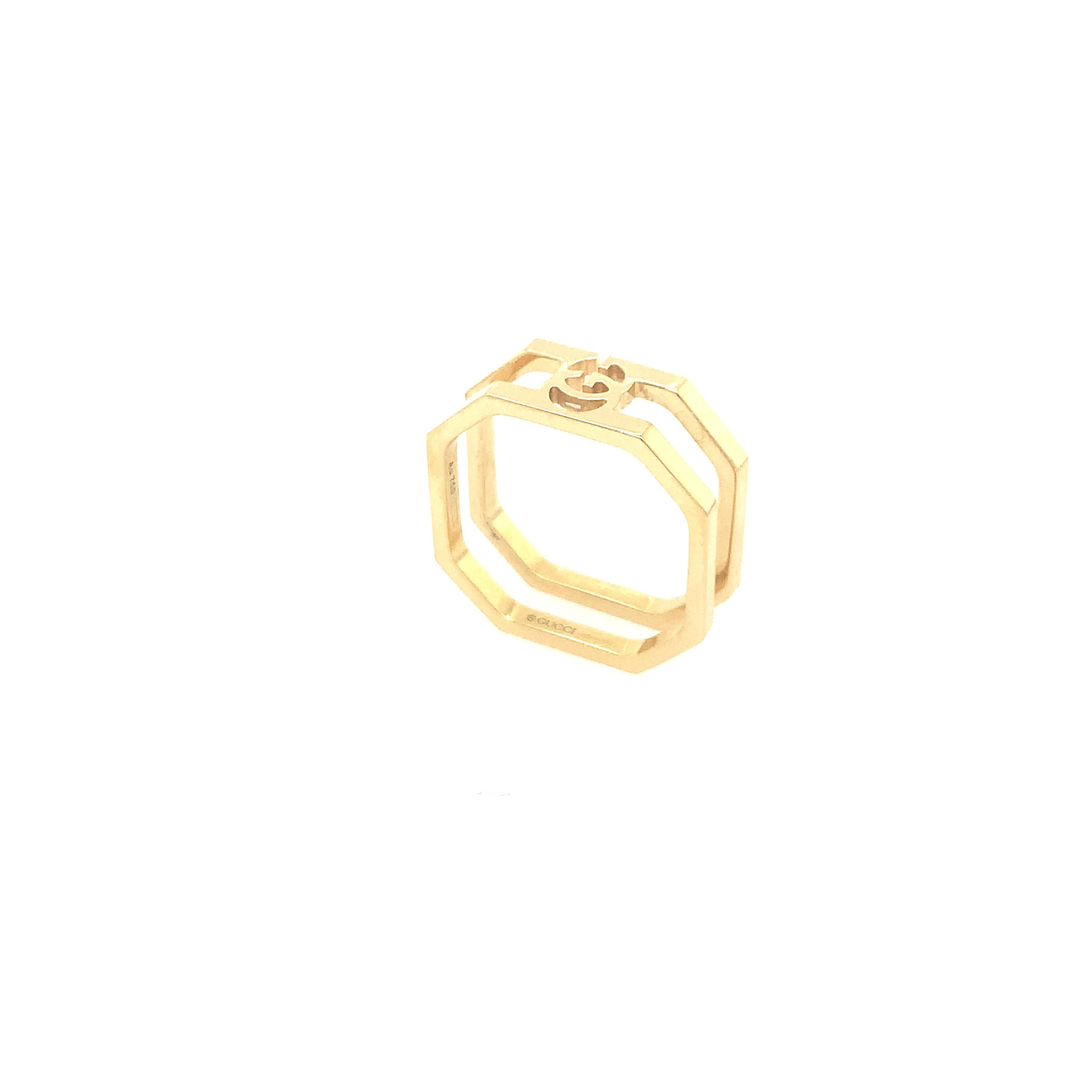 The Gucci running double ring is crafted from 18K yellow gold and designed with cut edges featuring the signature GG logo. With an octagonal shape, this Gucci ring is elegant and timeless. Subtly stylish, this ring is a rare Gucci find. 