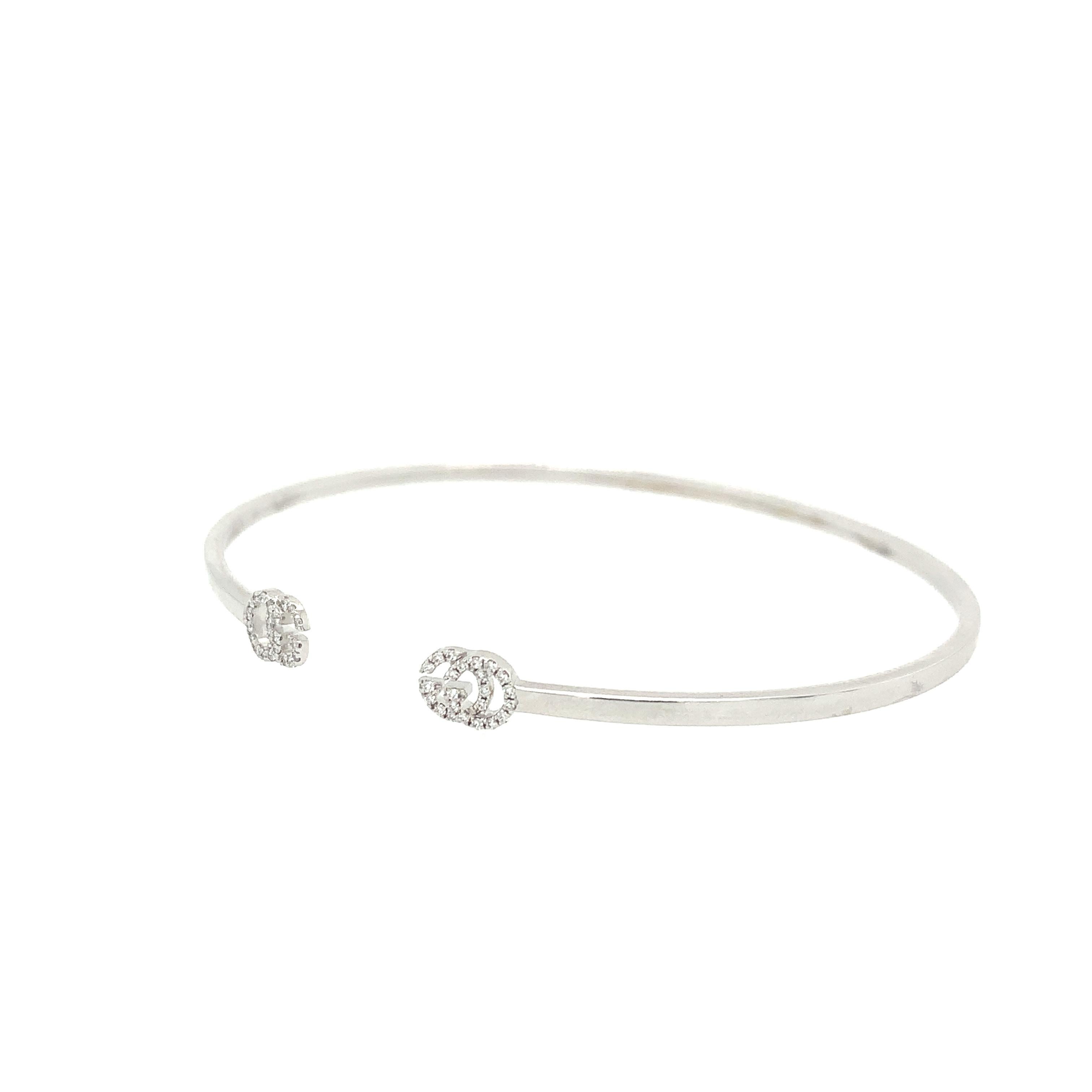 Clean lines with an elegant feel, the 18K white gold cuff, featuring a diamond-encrusted Double G at either end, adds a classic touch to Gucci's fine jewelry collection. The thin design allows this style to be worn stacked with other bracelets or on