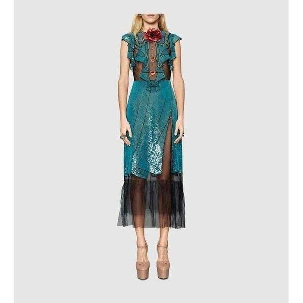 Beautifully embroidered on black tulle, this dress explores the concept of illusion with its trompe l’oeil sequined frills and stealthy beaded snake back. The gorgeous jewelled buttons are an Alessandro Michele calling card.

Illusion tulle with