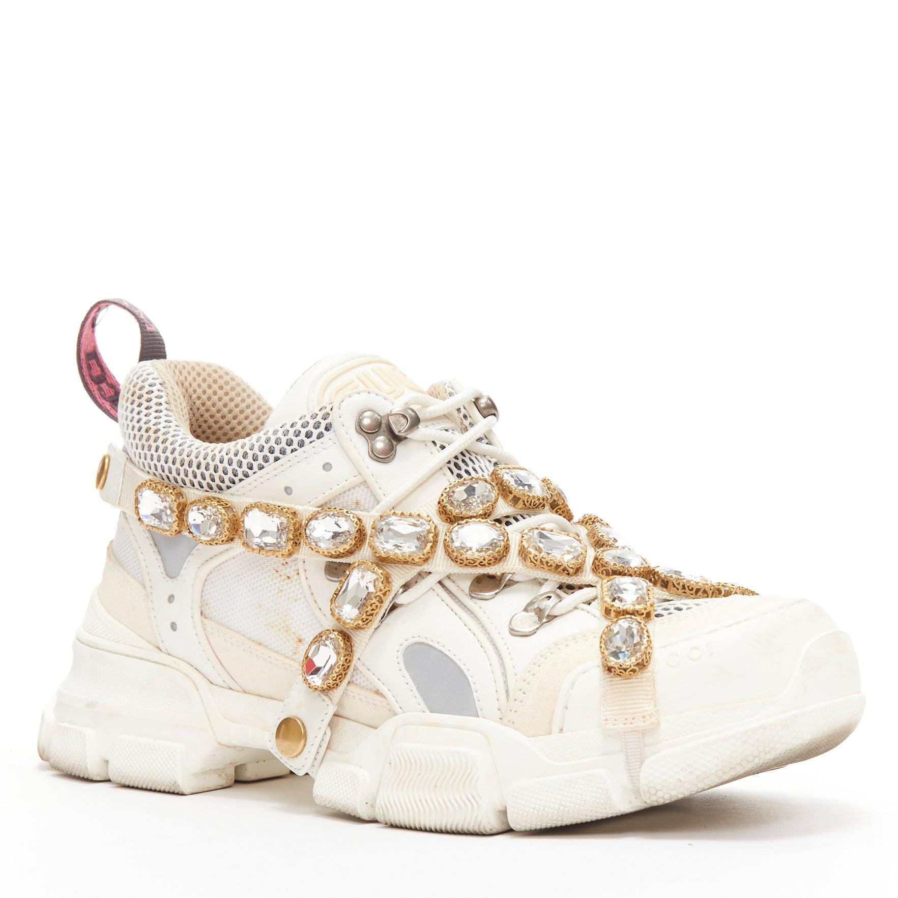GUCCI Runway Flashtrek cream crystal harness chunky sneakers EU38
Reference: CNPG/A00044
Brand: Gucci
Designer: Alessandro Michele
Model: Flashtrek
Material: Fabric, Leather
Color: Cream, Gold
Pattern: Solid
Closure: Lace Up
Lining: Beige Mesh
Extra
