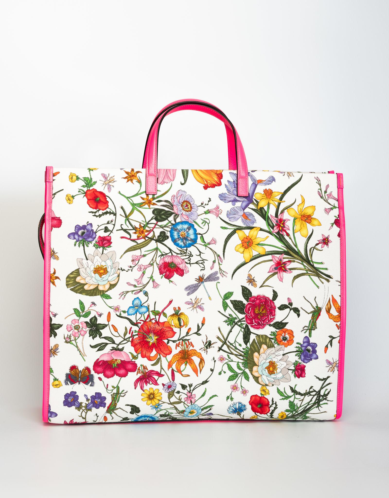 This Gucci tote bag is made out of white and pink cotton fabric with floral print and leather trim. Featuring round top handles, gold-tone hardware, a top zip fastening, a main internal compartment and an internal logo patch. 
     

COLOR: