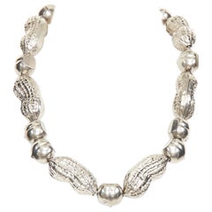 GUCCI Runway hazelnut peanut charm textured interlocking GG silver tone necklace