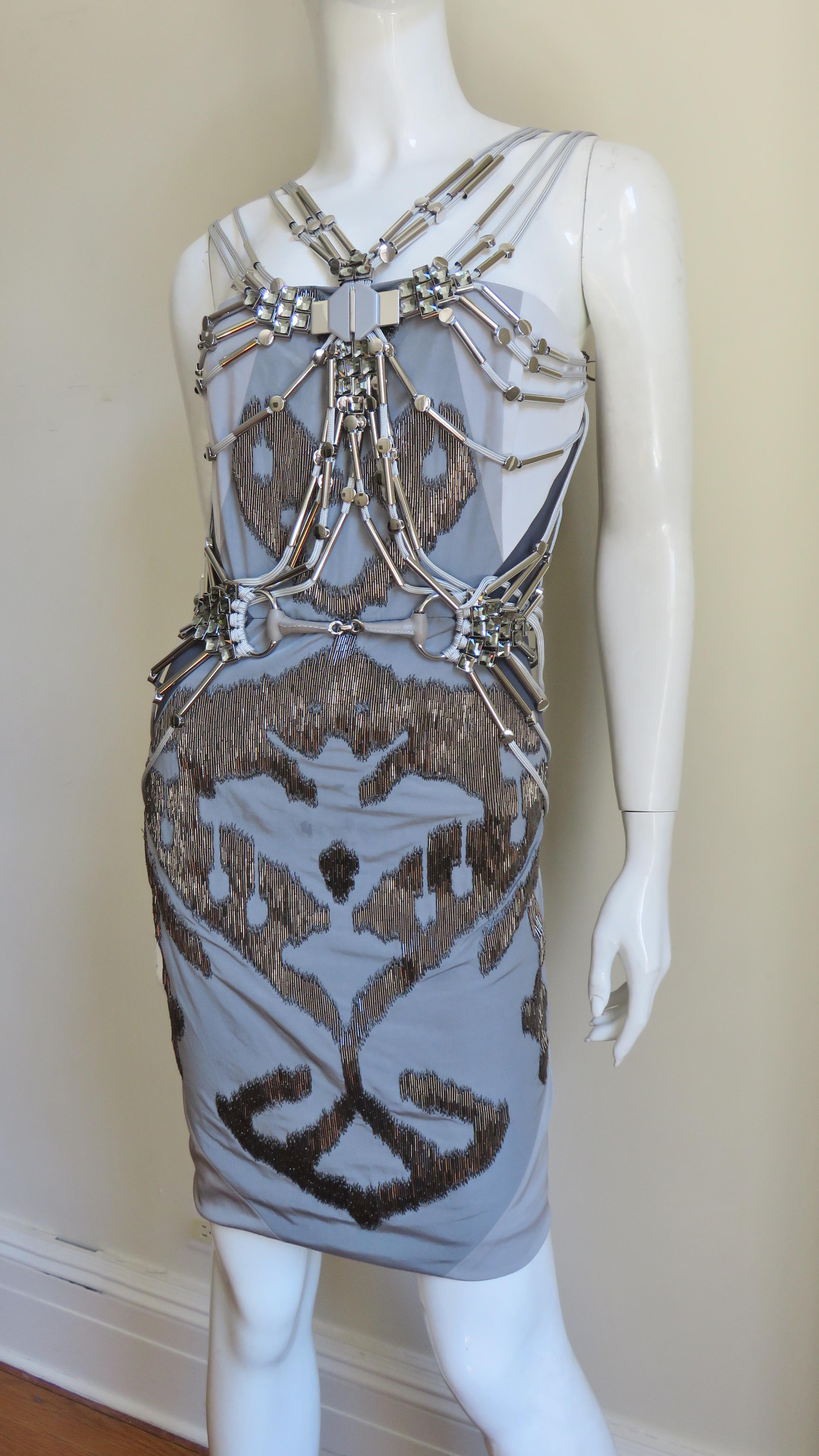 A gorgeous silk dress in shades of grey from Gucci in a version worn on numerous covers including by Jennifer Lopez and Pink. It is a semi fitted dress covered in front with an elaborate burnished glass tubular beaded Ikat print and an intricate