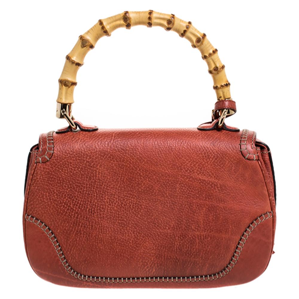 This Gucci bag combines style and elegance into the ultimate everyday bag. Crafted in Italy, it is made from quality leather and comes in a lovely shade. It is accented with a signature bamboo top handle. Secured with a bamboo turn-lock closure, the