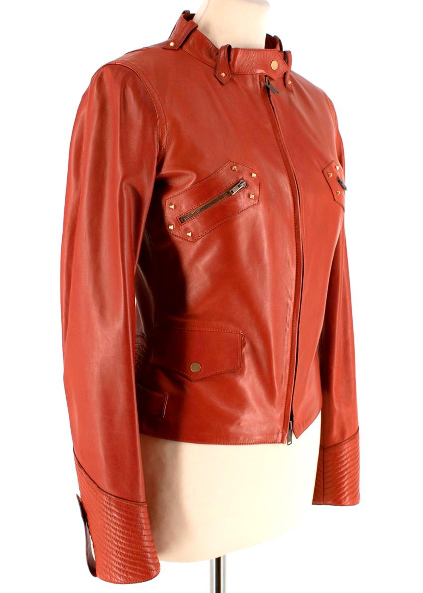 Gucci Rust Leather Studded Biker Jacket

- Soft rust coloured leather 
- Gold hardware stud detailing 
- Zipped pockets on chest and lower press-stud pockets 
- Leather embossed detailing on lower back 
- Silk lining 
- Front zip fastening