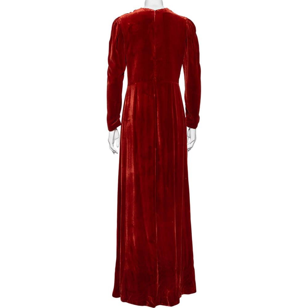 This Gucci long-sleeved gown is worthy of a place in your closet. The rust-colored velvet creation is draped beautifully and features an intricately embroidered patch at the waist. Perfect for those special occasions!

