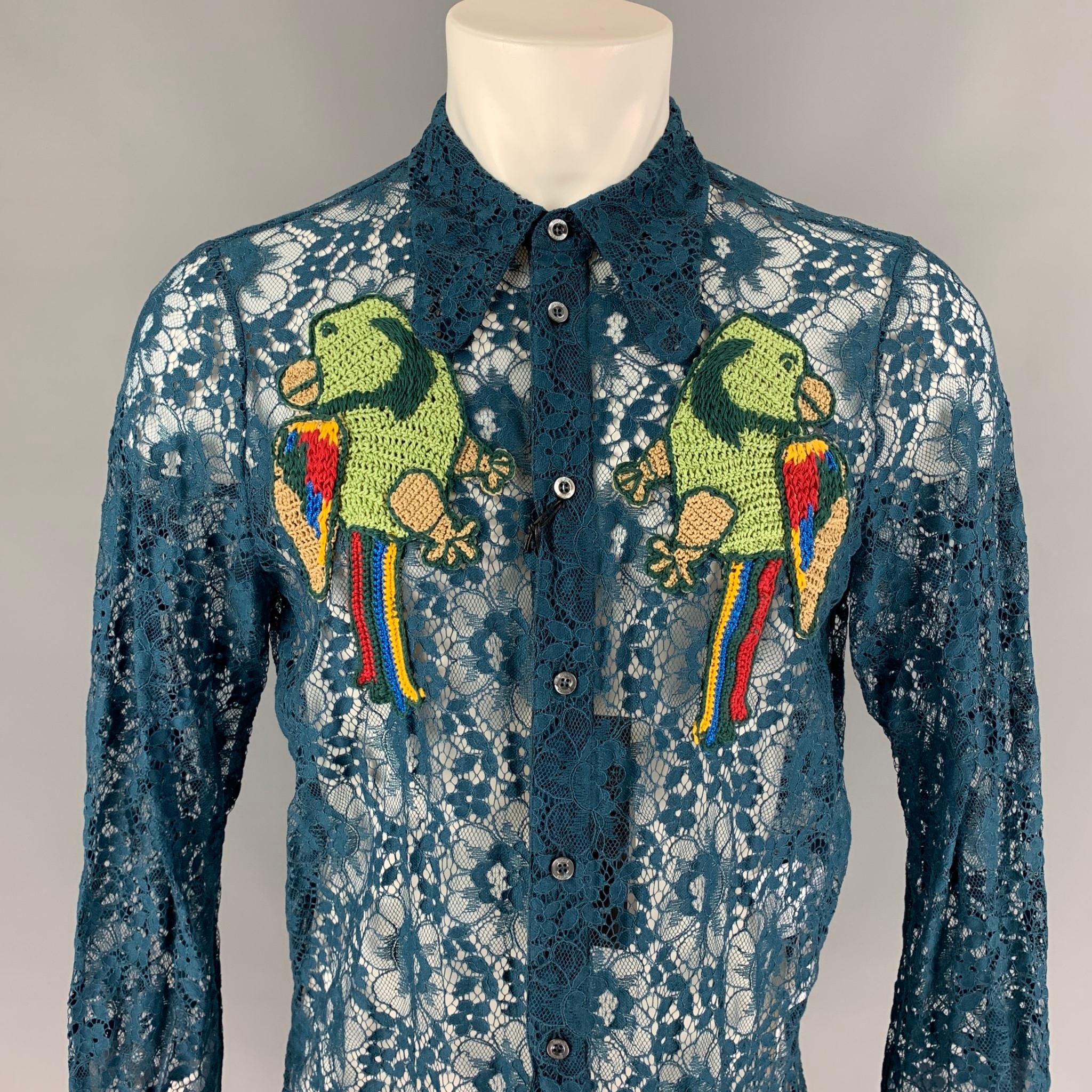 GUCCI S/S 16 long sleeve shirt comes in a teal sheer lace polyamide blend with front embroidery details featuring a pointed collar and a buttoned closure. Made in Italy.

New With Tags.
Marked: 52

Measurements:

Shoulder: 16.5 in.
Chest: 42