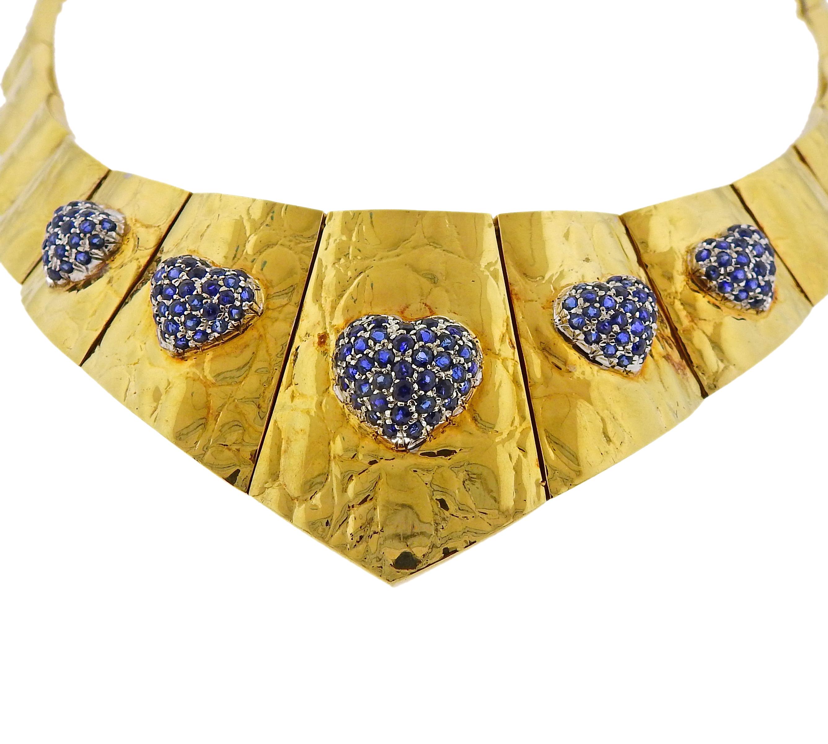 Vintage Gucci 18k gold necklace, featuring five blue sapphire set hearts. Necklace is 14.5' long and 40mm at the widest point. Marked Gucci, Italy, 750, 18k. Weighs 93.5 grams.

SKU#N-02940