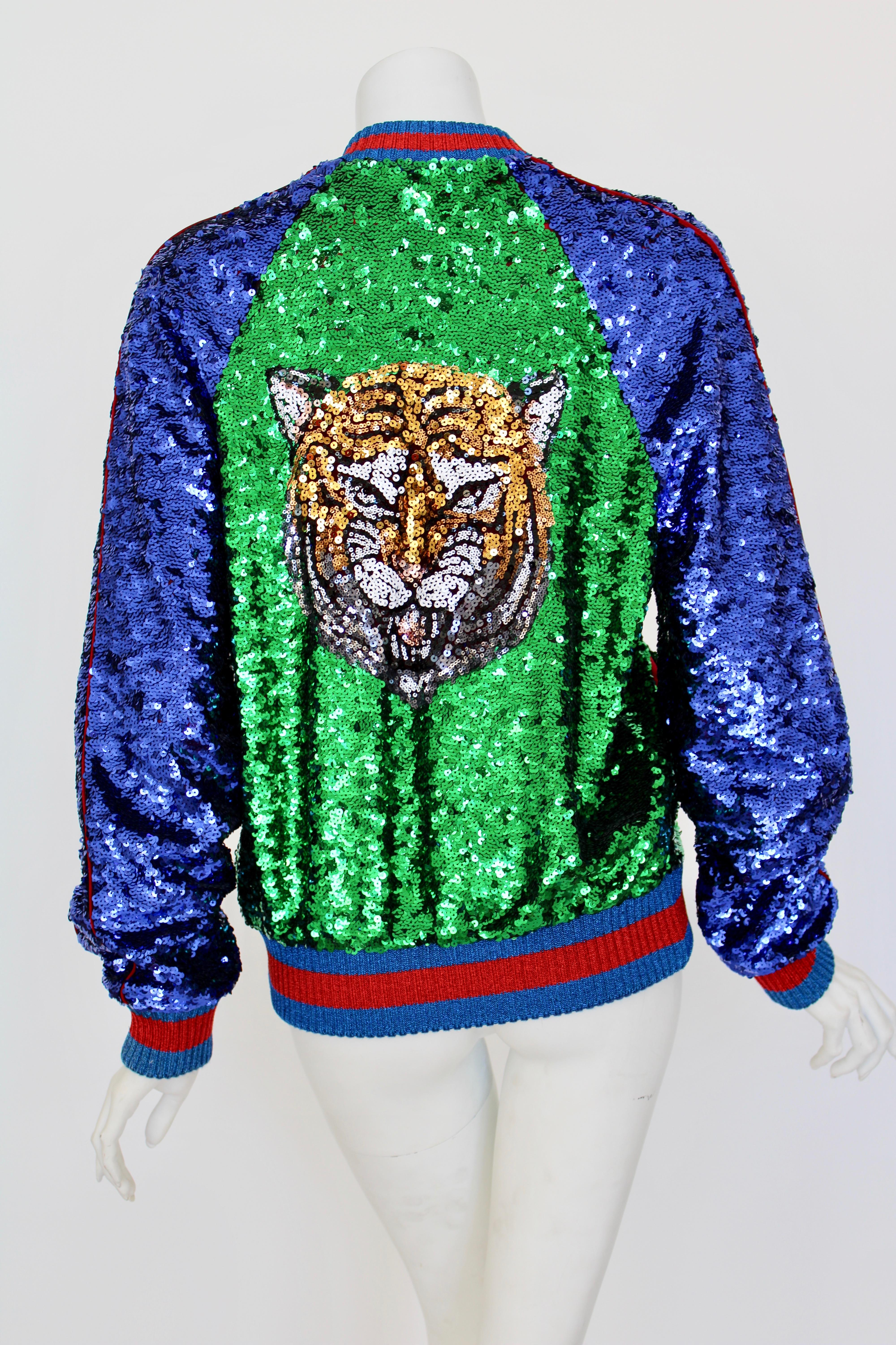 This glittering multicolour cotton blend sequinned bomber jacket from Gucci is a scintillating, stand-out. The perfect party piece it features a ribbed collar, long length raglan sleeves, a front zip fastening, two front pockets, and a Sylvie Web