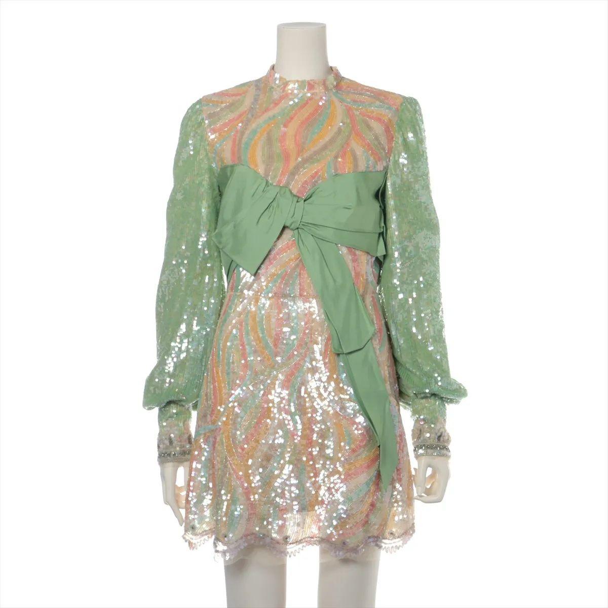 The Gucci Sequins Silk Ribbon Long Sleeve Mini Dress in Orange and Green is a dazzling statement piece that captures the brand's bold and eclectic spirit. Crafted from luxurious silk, the dress features vibrant orange and green sequins intricately