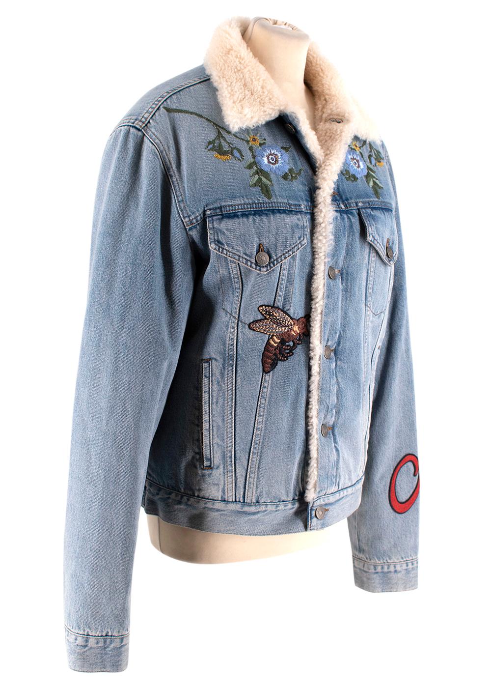 Gucci Shearling-Lined Embroidered Denim Jacket

- Light blue bleach denim jacket 
- Shearling lining 
- Embroidered flowers, butterflies, tiger and 'L'Aveugle Par Amour' appliques 
- Front buttoned patch and side slit pockets 
- Gucci embossed