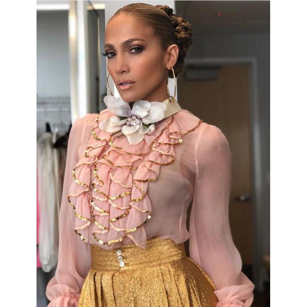 Designed with gold sequin trims, this ruffle blouse features an abundance of interest at the chest with a contrasting rounded edge pointed cream collar, ruched embellishments at the chest and long sleeves with elasticated flared cuffs.
This