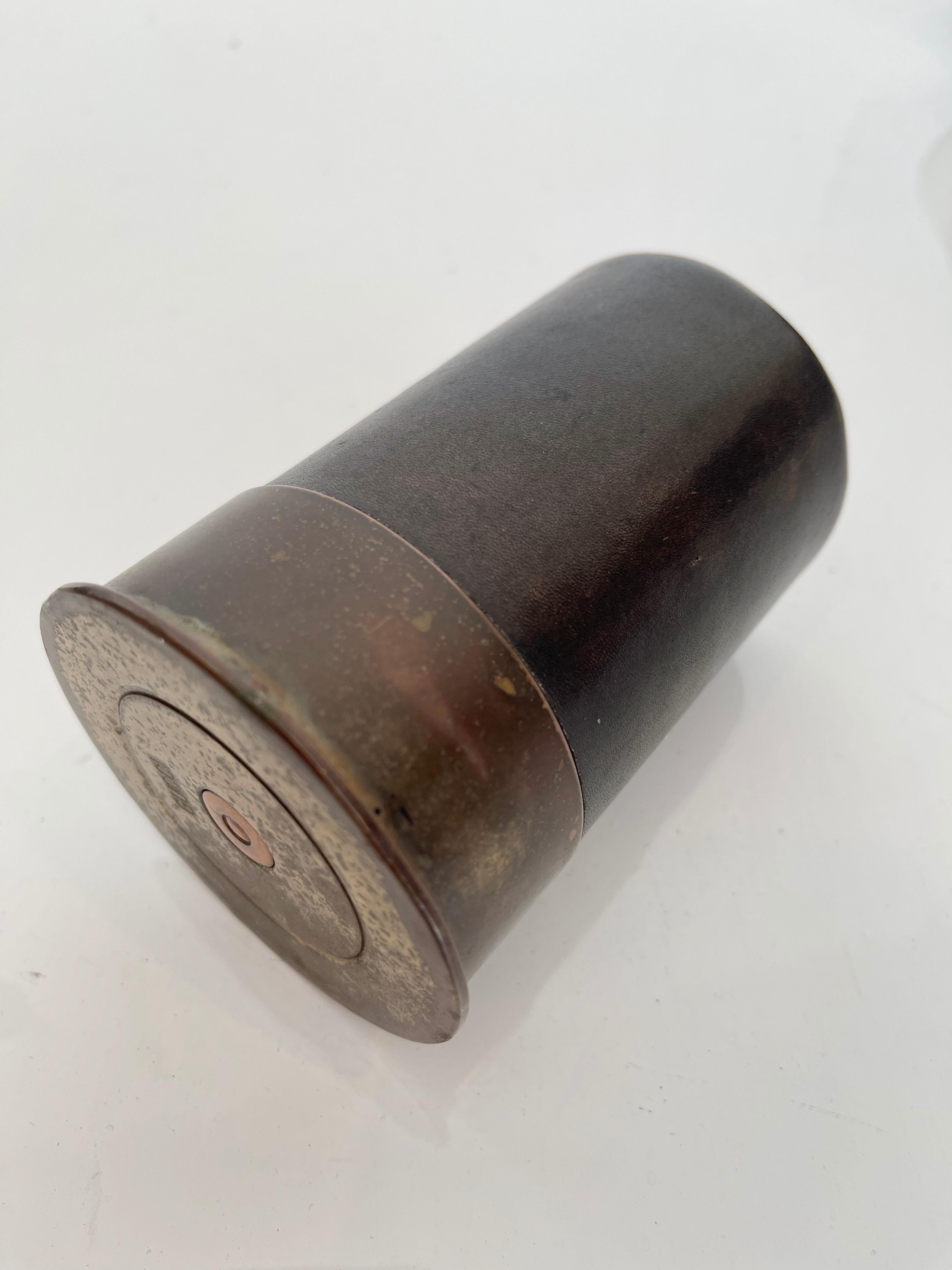 Unusual leather cup with brass bottom made by Gucci. In the shape/style of a shotgun shell. Stamped Gucci on underside of brass. Stamped Gucci on inside of leather cup. Good vintage condition. Great desktop item with functionality and fun design.