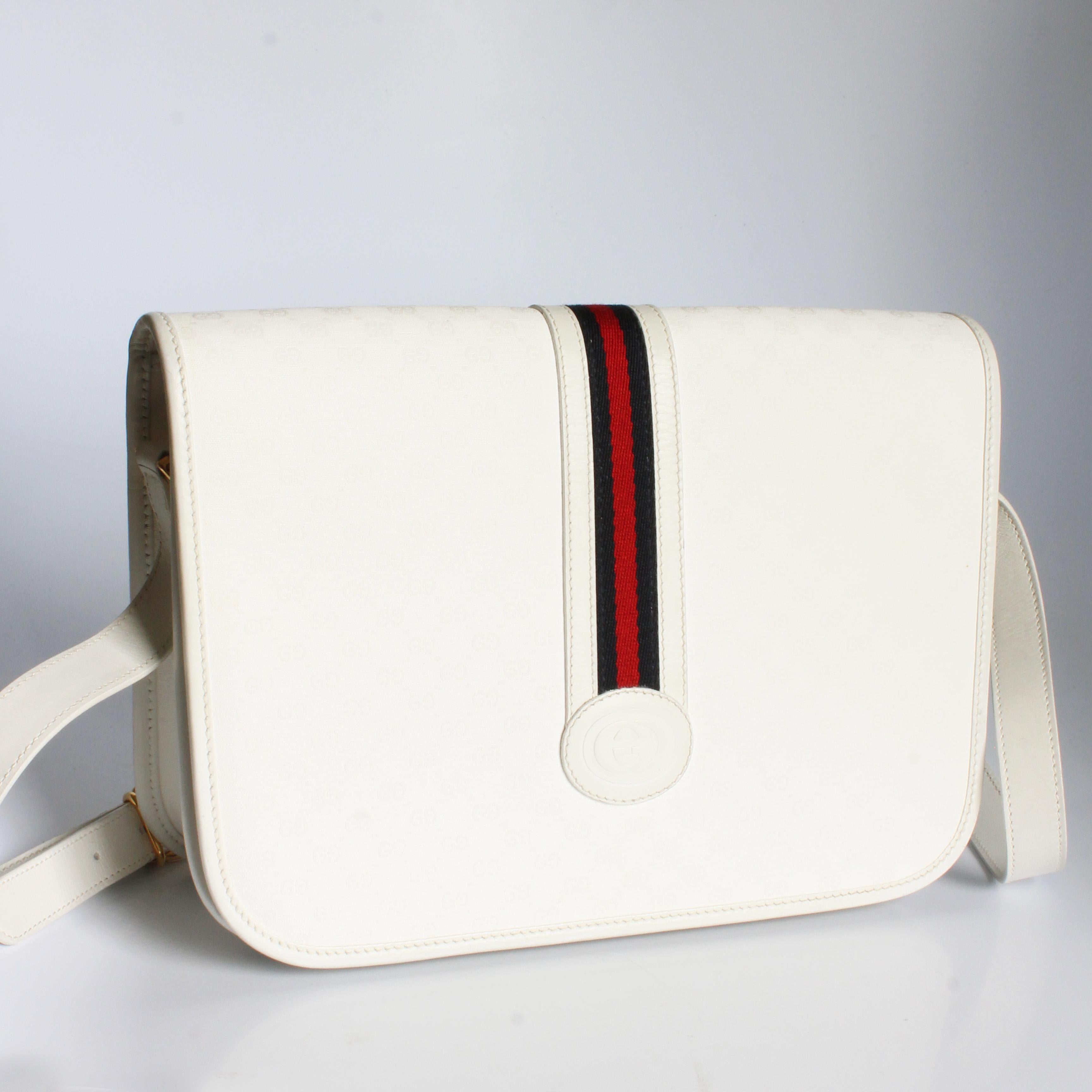 Authentic, preowned, vintage Gucci shoulder bag, likely made in the late 70s.  Made from white GG coated canvas, it's trimmed in white leather and has Gucci's signature webbing and GG logo on the front flap.  It fastens with a magnetic snap, has