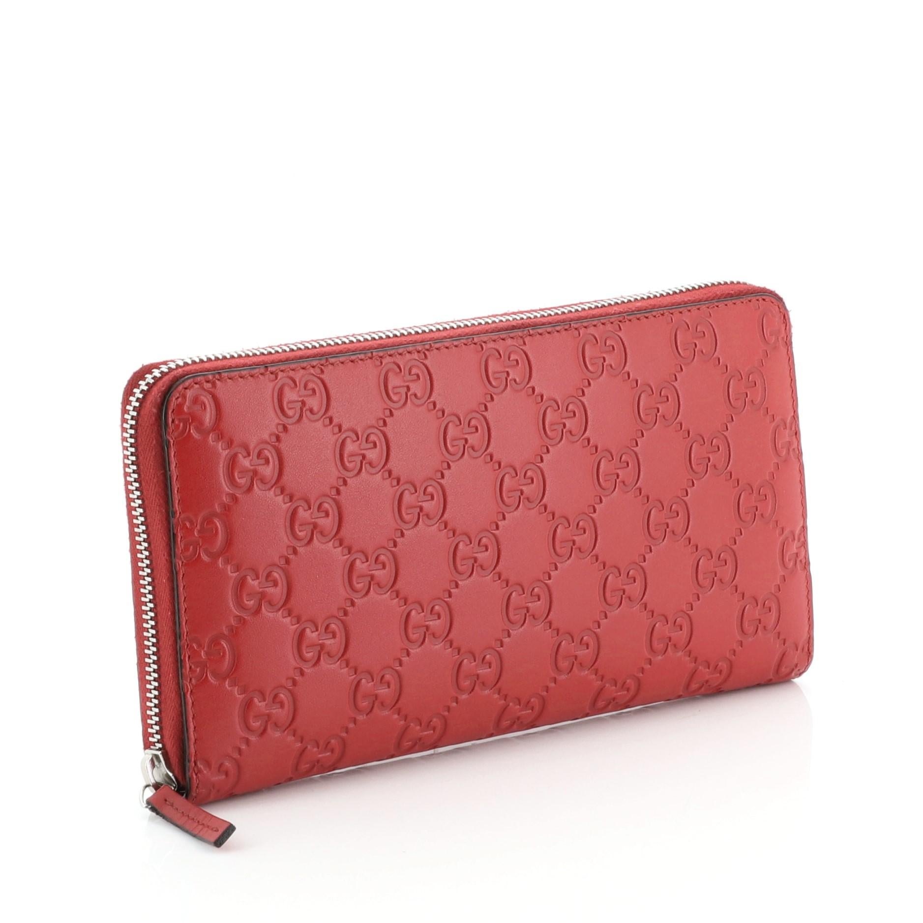 This Gucci Signature Zip Around Wallet Guccissima Leather, crafted in red leather, features silver-tone hardware. Its zip closure opens to a red leather interior with multiple card slots and zip pocket. 

Estimated Retail Price: $630
Condition: