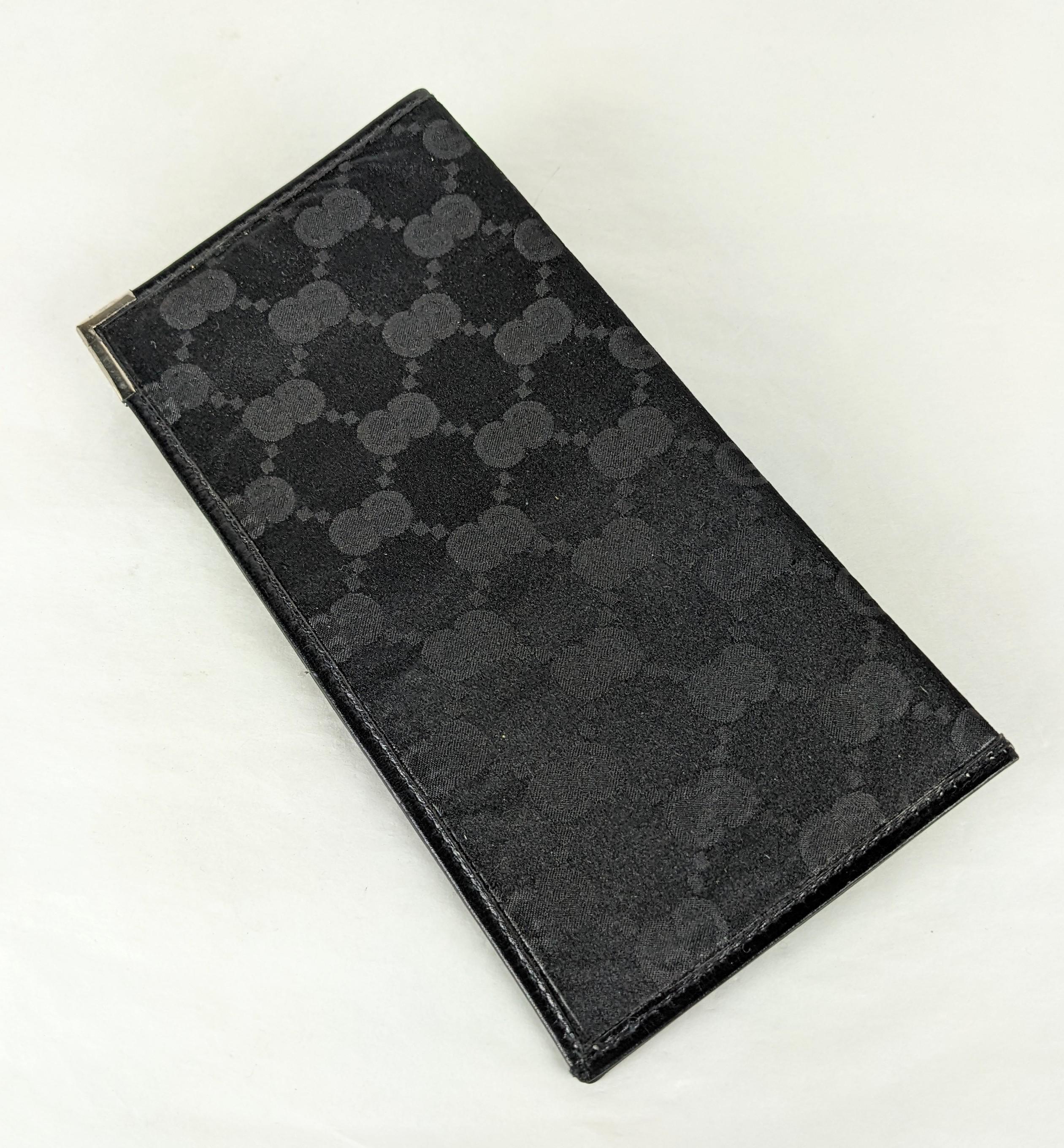 Gucci Silk and Leather Money Fold from the 1980's. Silk satin logo textile exterior with black calf leather binding and interior and sterling silver corner tips. 6.5