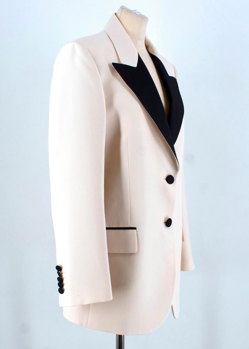 Gucci Silk Blazer 

- Cream in colour
- Black trimmings, buttons and lapels
- 2 buttons to the front
- 2 pockets to the front
- 4 buttons to each cuff
- Slit to the back
- Fully lined
- Tailored

Please note, these items are pre-owned and may show