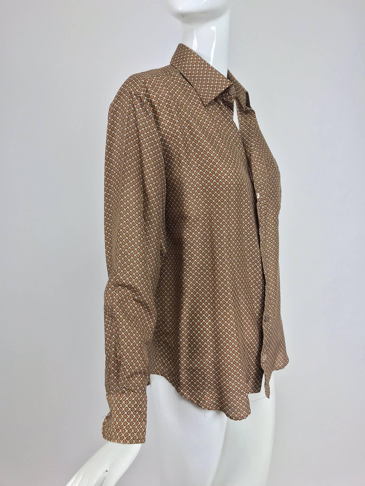 Gucci silk foulard shirt in caramel, cream and blue print from the 1960s...G. Gucci label...Long sleeve button front shirt with banded cuffs, yoke back single chest pocket...Mens shirt marked 15 1/2  39...
In excellent wearable condition... All our