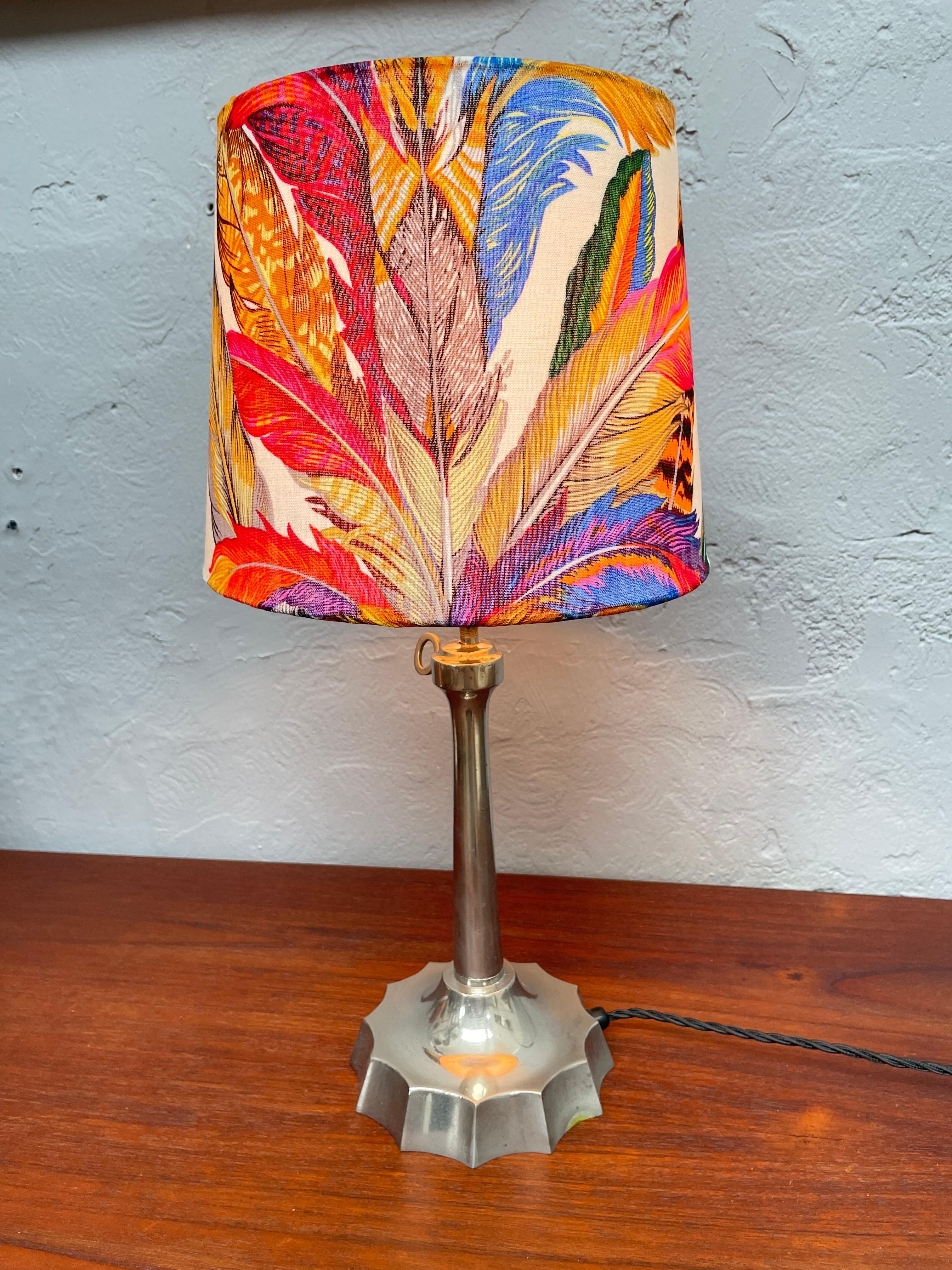 A stunning lampshade handmade from an original silk Gucci Indian tribal headdress scarf. 
Striking colors and with an iconic printed pattern this shade would fit into any household decor. 
And mounted onto a vintage lamp it just looks so