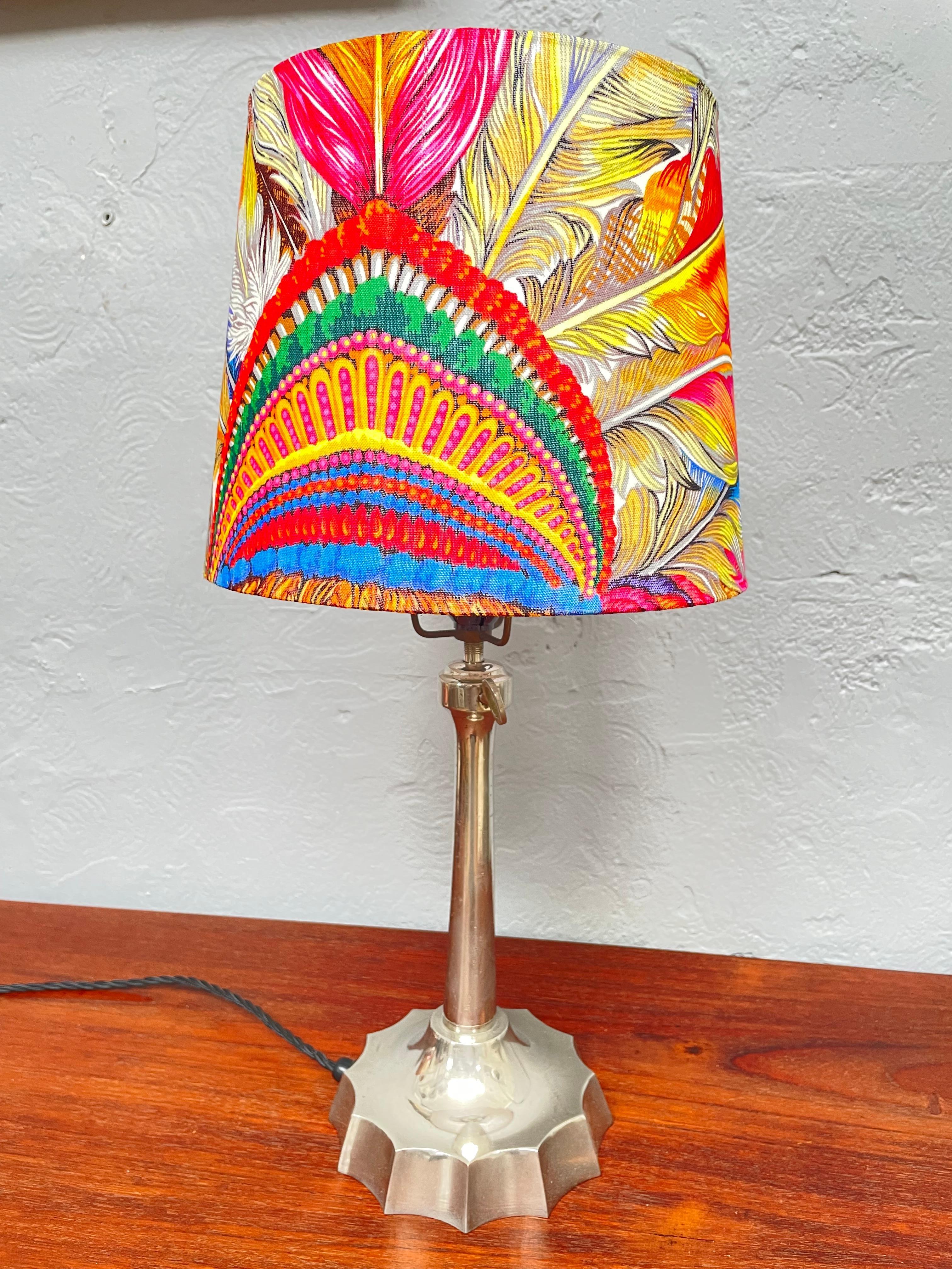 A stunning lampshade handmade from an original silk Gucci Indian tribal headdress scarf. 
Striking colors and with an iconic printed pattern this shade would fit into any household decor. 
And mounted onto a vintage lamp it just looks so