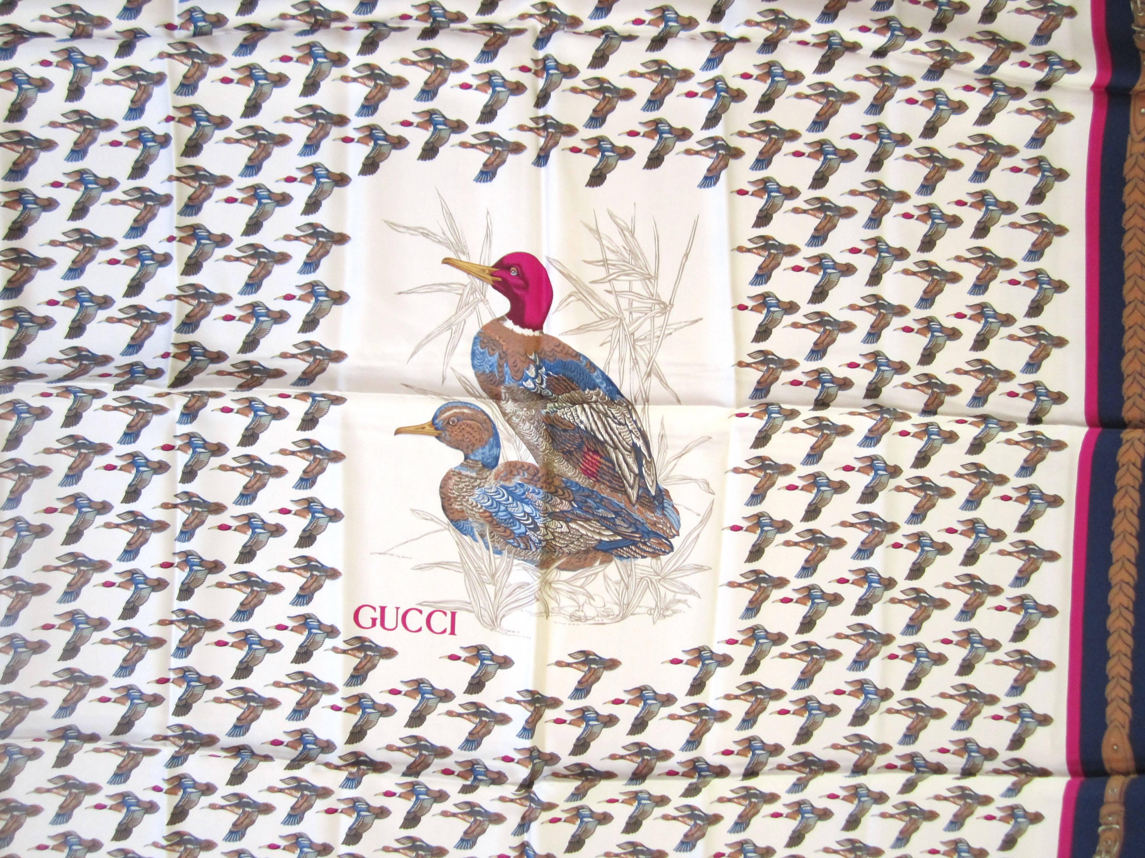 Another wonderful Gucci silk scarf. Has a wonderful Bird Mallard Motif with a deep blue border. measuring 34 x 34. Made in Italy. We have other Gucci, Escada and Hermes scarves in our storefront. This was purchased and never worn! This is out of a