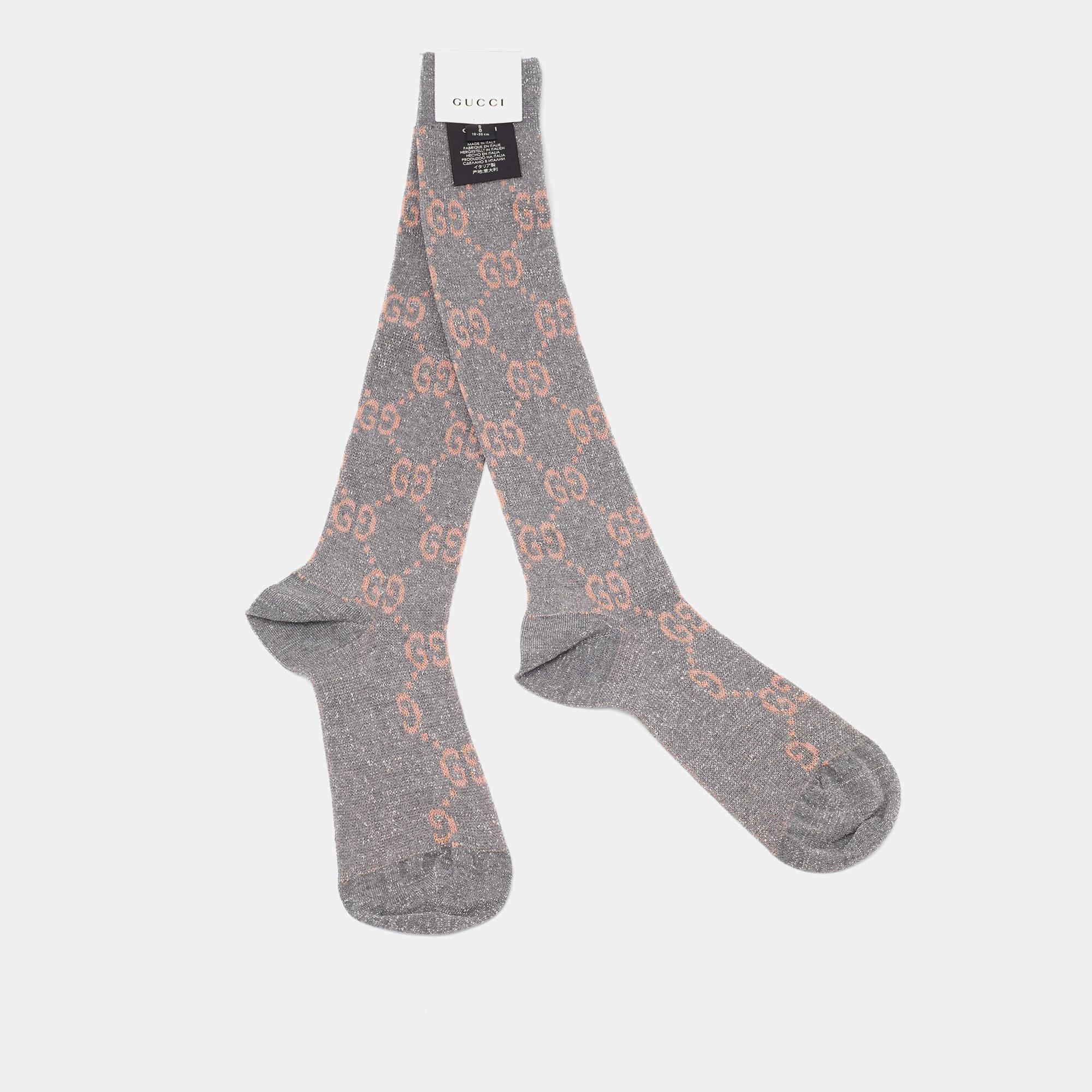 Gucci's knee-high socks feature a beige and silver logo monogram design in Lurex knit. The luxurious blend ensures comfort and style, making them a statement accessory for fashion-forward individuals.

Includes: Brand tab
