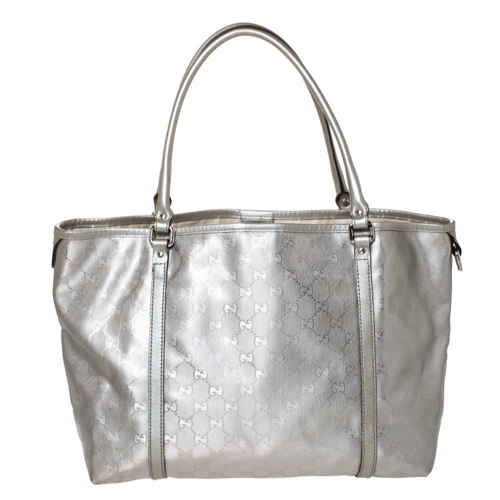 This chic and feminine shopper tote is from Gucci. The bag is made from GG Imprime canvas and is styled with leather trims. It features a zip closure that opens to a fabric-lined interior that can fit your daily essentials. Flaunt this silver-hued