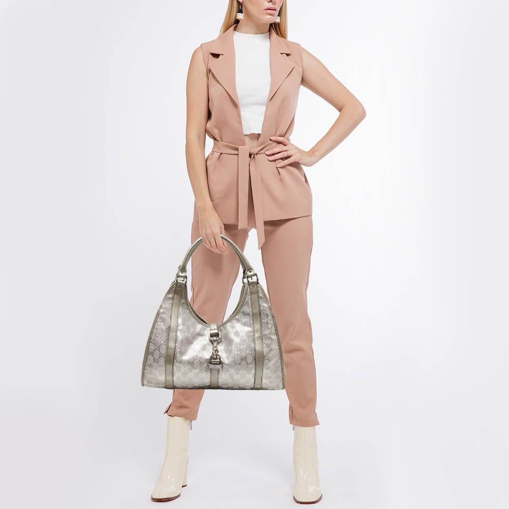 The simple silhouette and the use of GG Imprime Crystal canvas and leather for the exterior bring out the appeal of this Gucci bag. It features dual handles, silver-tone hardware, and a canvas-lined interior.