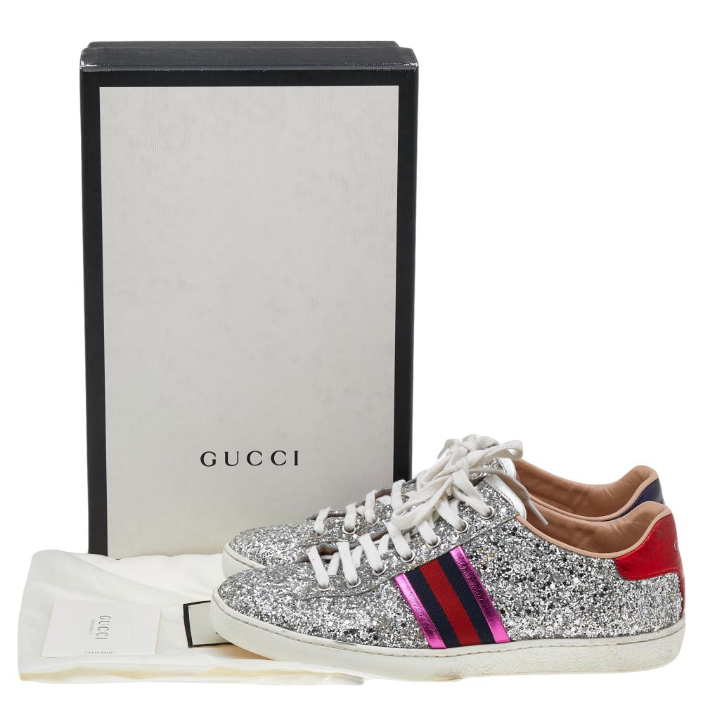 Stacked with signature details, this Gucci pair is rendered in silver glitter & leather and is designed in a low-cut style with lace-up vamps. They have been fashioned with the iconic Web stripes. Complete with the brand label on the counters, these