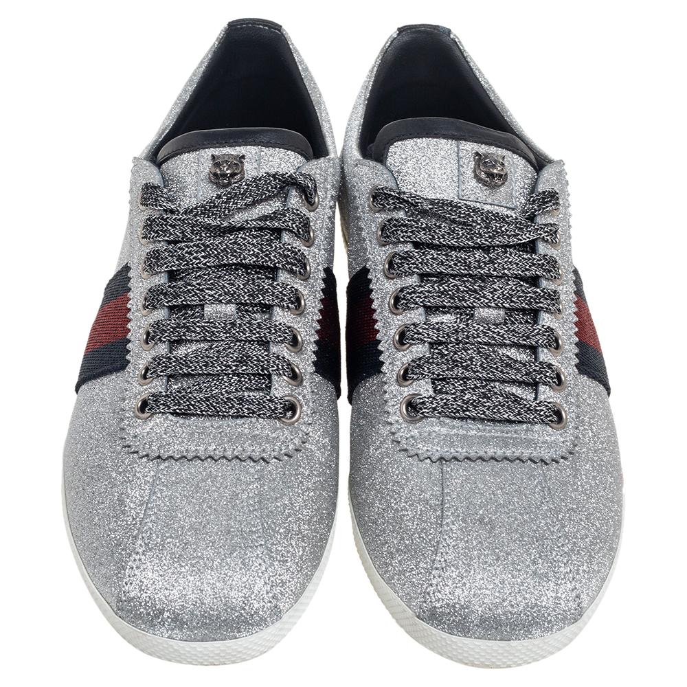 Stacked with signature details, this Gucci pair is rendered in silver glitter and is designed in a low-cut style with lace-up vamps, studs on the counters, and Web trim on the sides. These shoes can be easily coordinated with your
