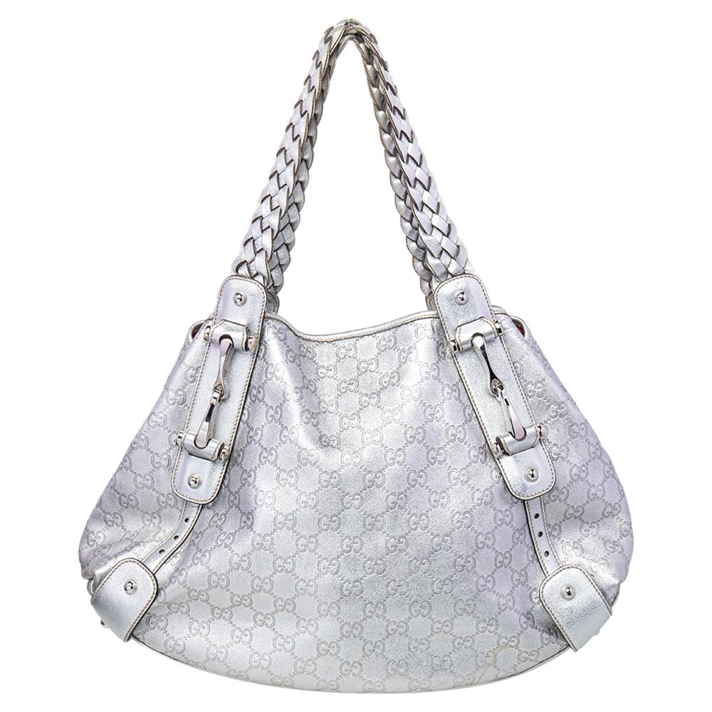 Take your style a notch higher with this Pelham hobo from Gucci. Cut out from Guccissima leather, the silver-hued bag features two braided leather handles, a spacious canvas-lined interior, and protective metal feet. This hobo is perfect for daily