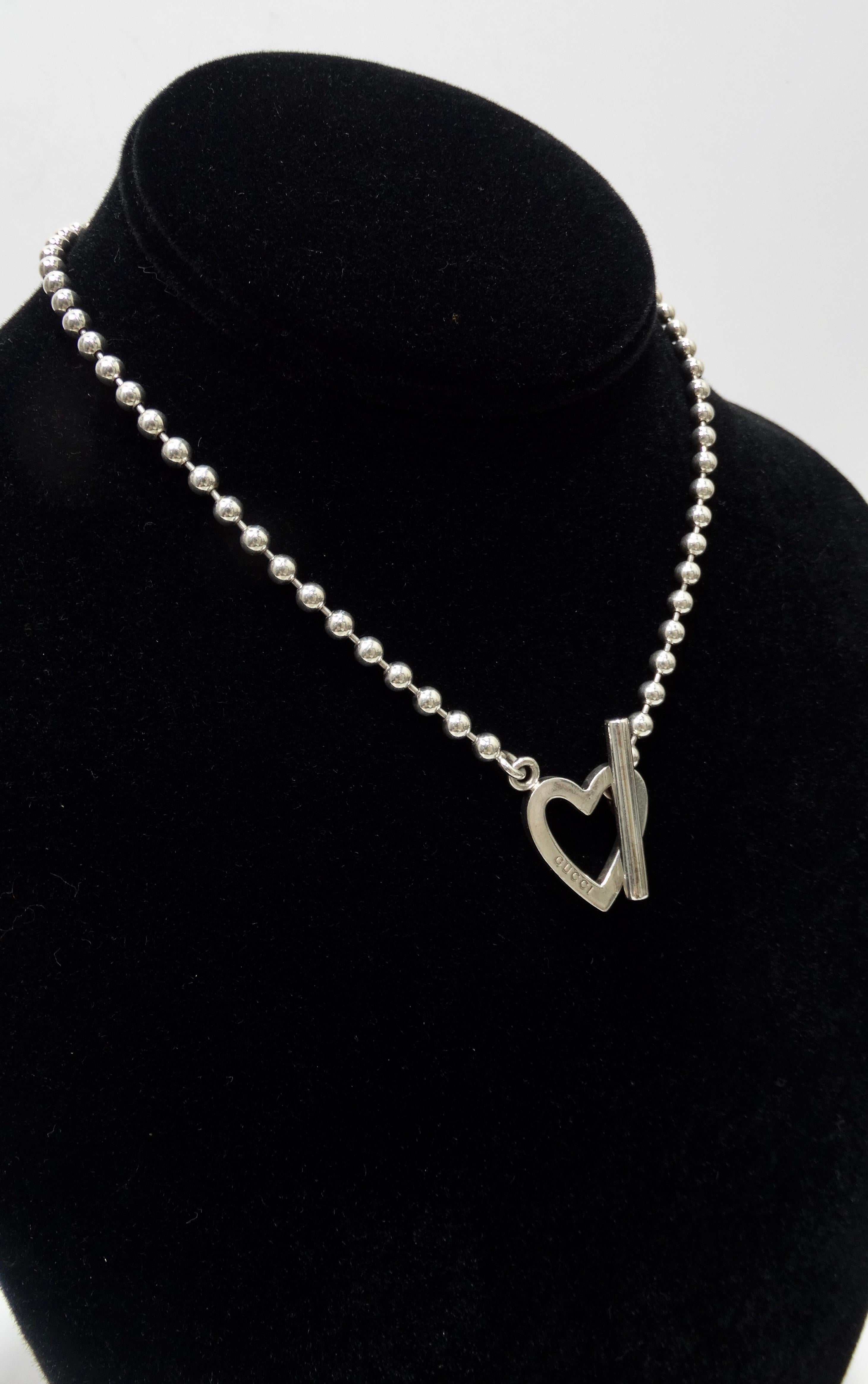 Show your love for Gucci with this adorable necklace! Circa 21st century, this genuine silver Gucci Heart necklace is the perfect addition to any Gucci collector's collection. Necklace features a boule chain with an open heart toggle closure.