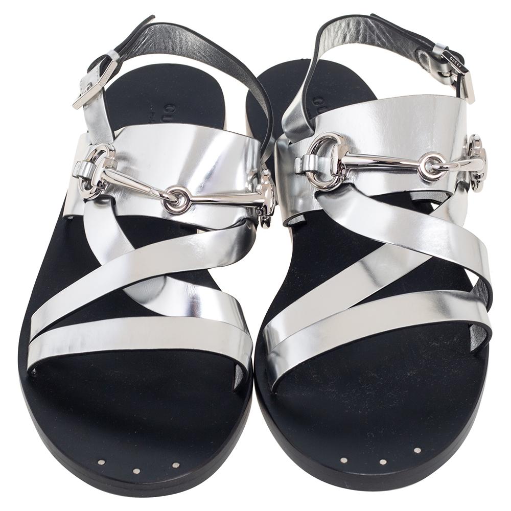 Gucci's caliber to combine its archival codes with modern silhouettes is evident in these flat sandals. They have been crafted from silver leather and designed with flat straps, the iconic Horsebit accent, and buckle closure.

Includes: Original