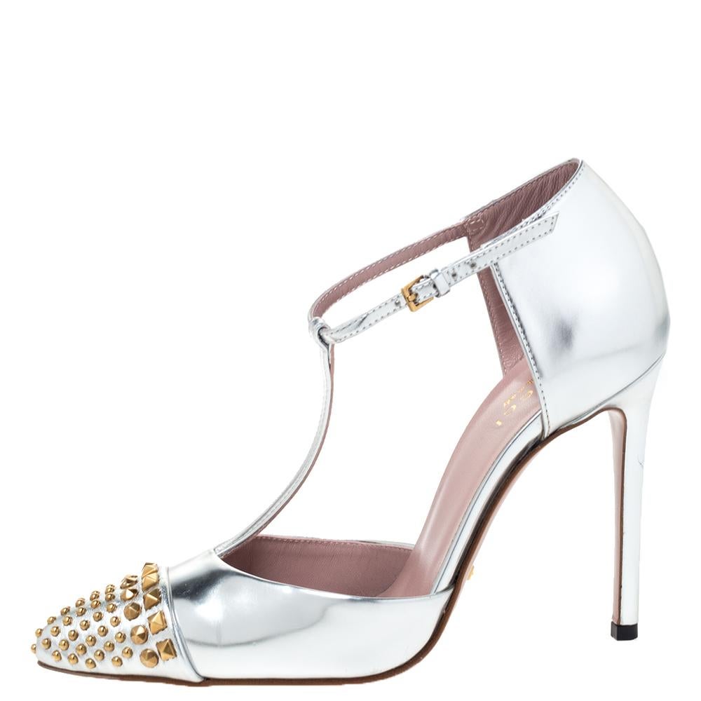 Essaying style in true Gucci style are these beautiful silver pumps. These intricately designed leather pumps have metal studs on the cap toe and are equipped with 