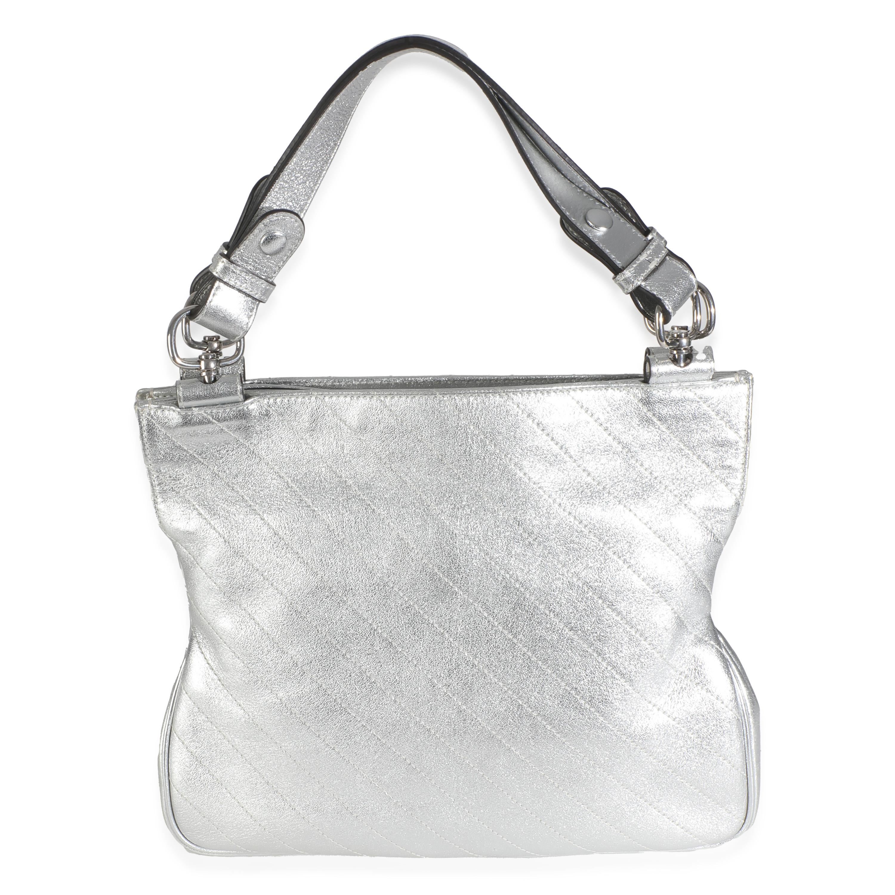 Listing Title: Gucci Silver Metallic Sakai Diagonal Stitched Calfskin Small Blondie Tote
SKU: 145888
Condition: Pre-owned 
Condition Description: The green and red Gucci Web was created in 1964 and has since been considered a recognizable signature