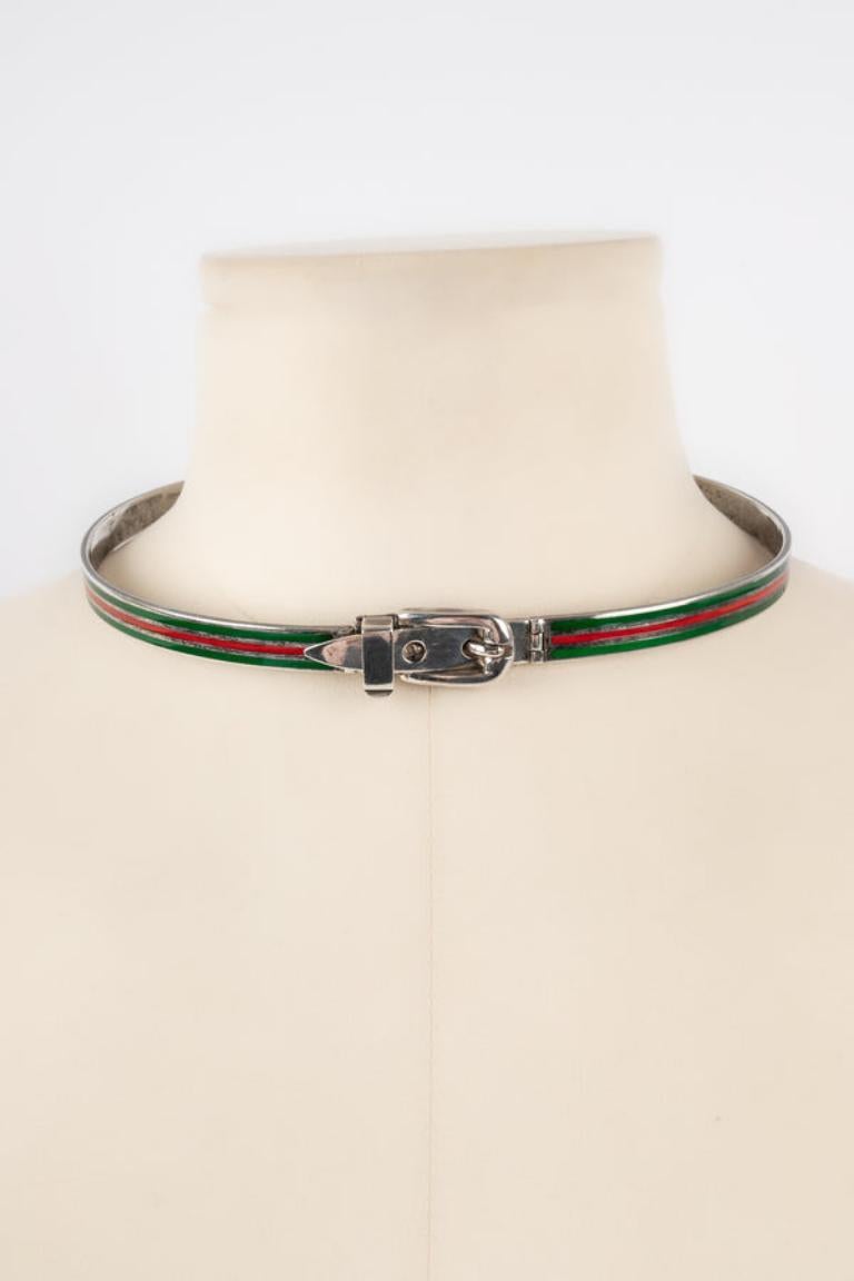 Gucci - Silver necklace decorated with green and red enamel. Good general condition but the enamel is damaged.

Additional information: 
Condition: Decent condition
Dimensions: Length of the neck circumference: 39 cm

Seller Reference: BC48