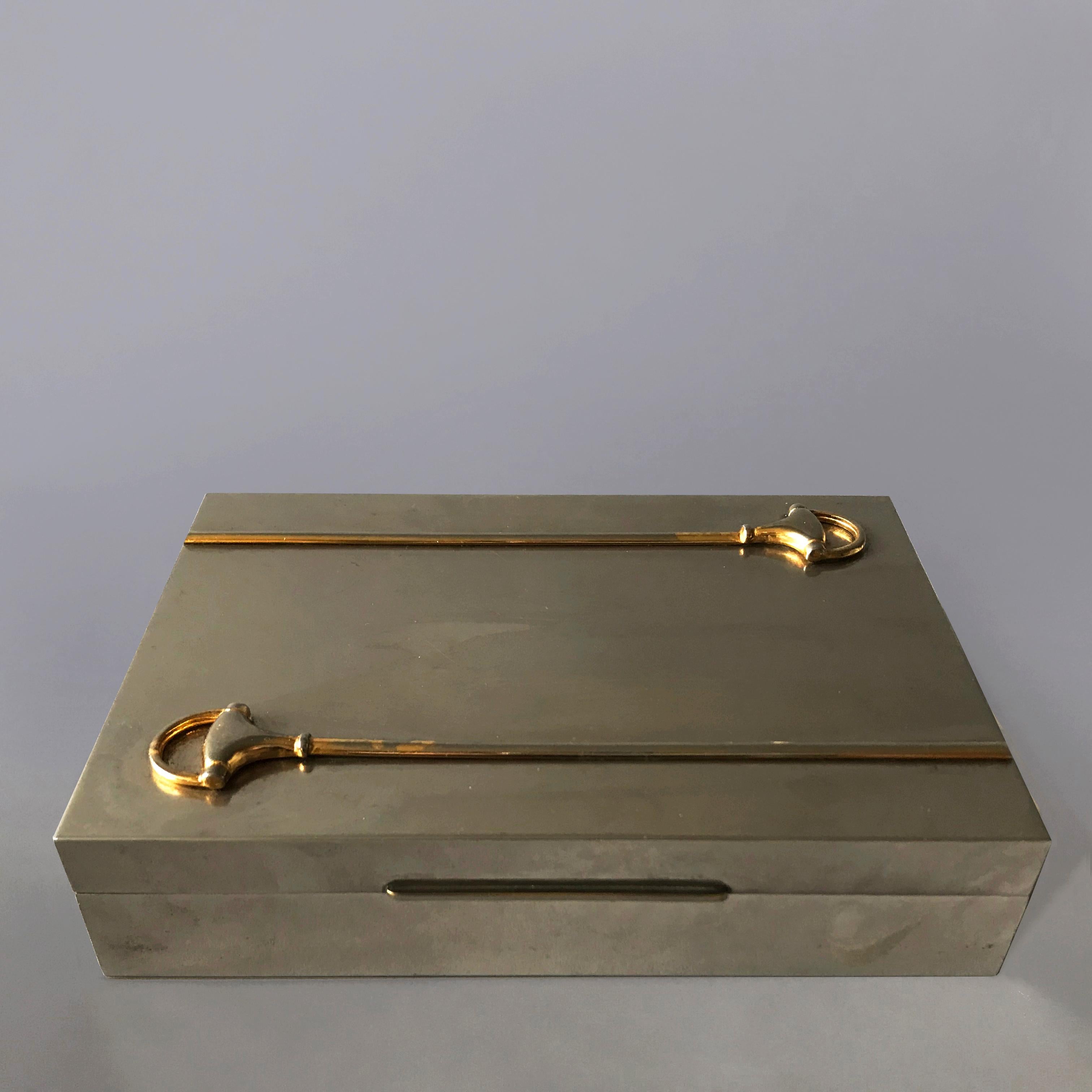 A stylish Gucci 1960s silver plated box with their iconic gold plated horsebit detail, with immaculate lacquered teak lining. Little dents on back left corner shown in last photo. Stamped 'Gucci Italy'.