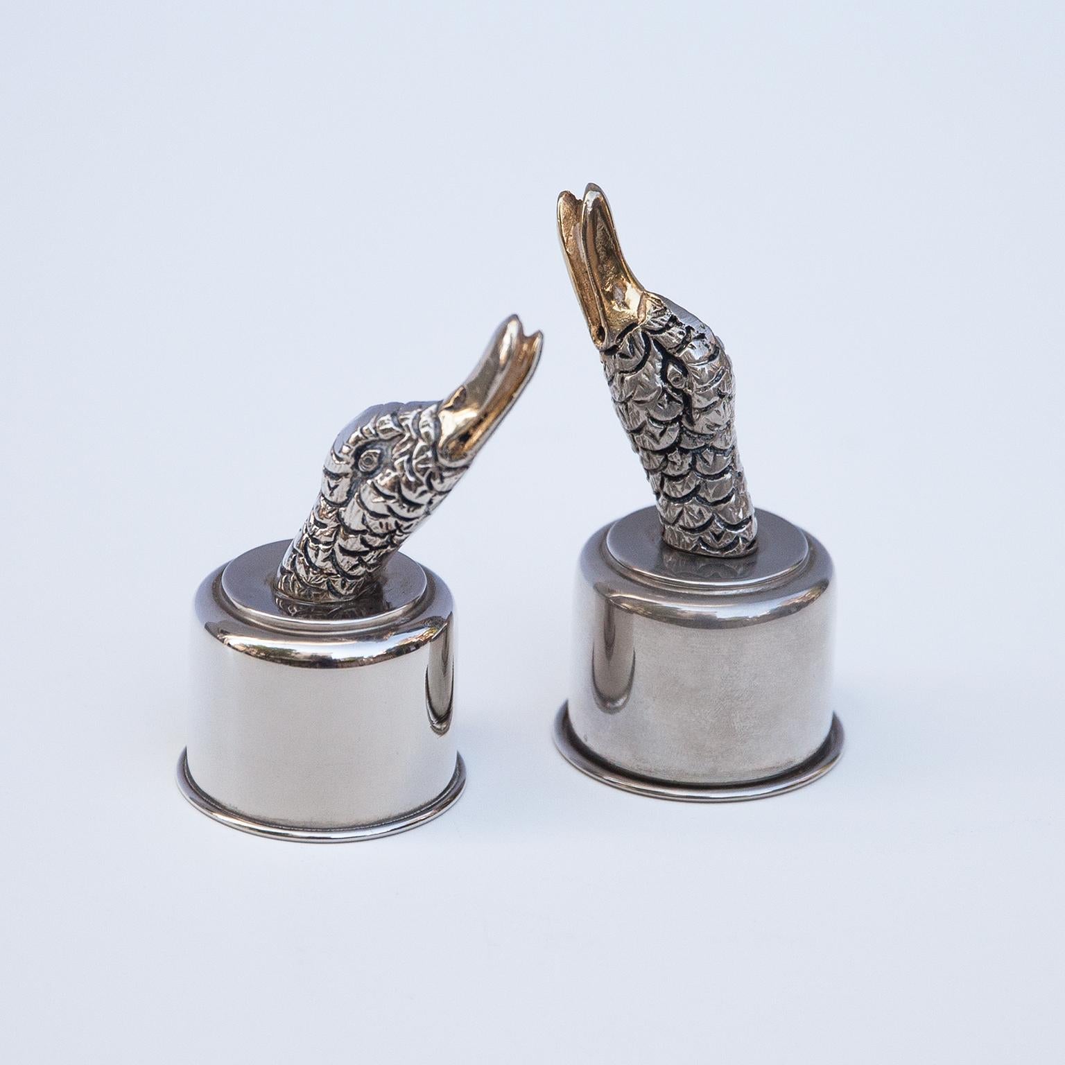 Elegant Gucci bottle caps made in silver and gold plate in form of a duck head, Italy 1970s and signed Gucci.