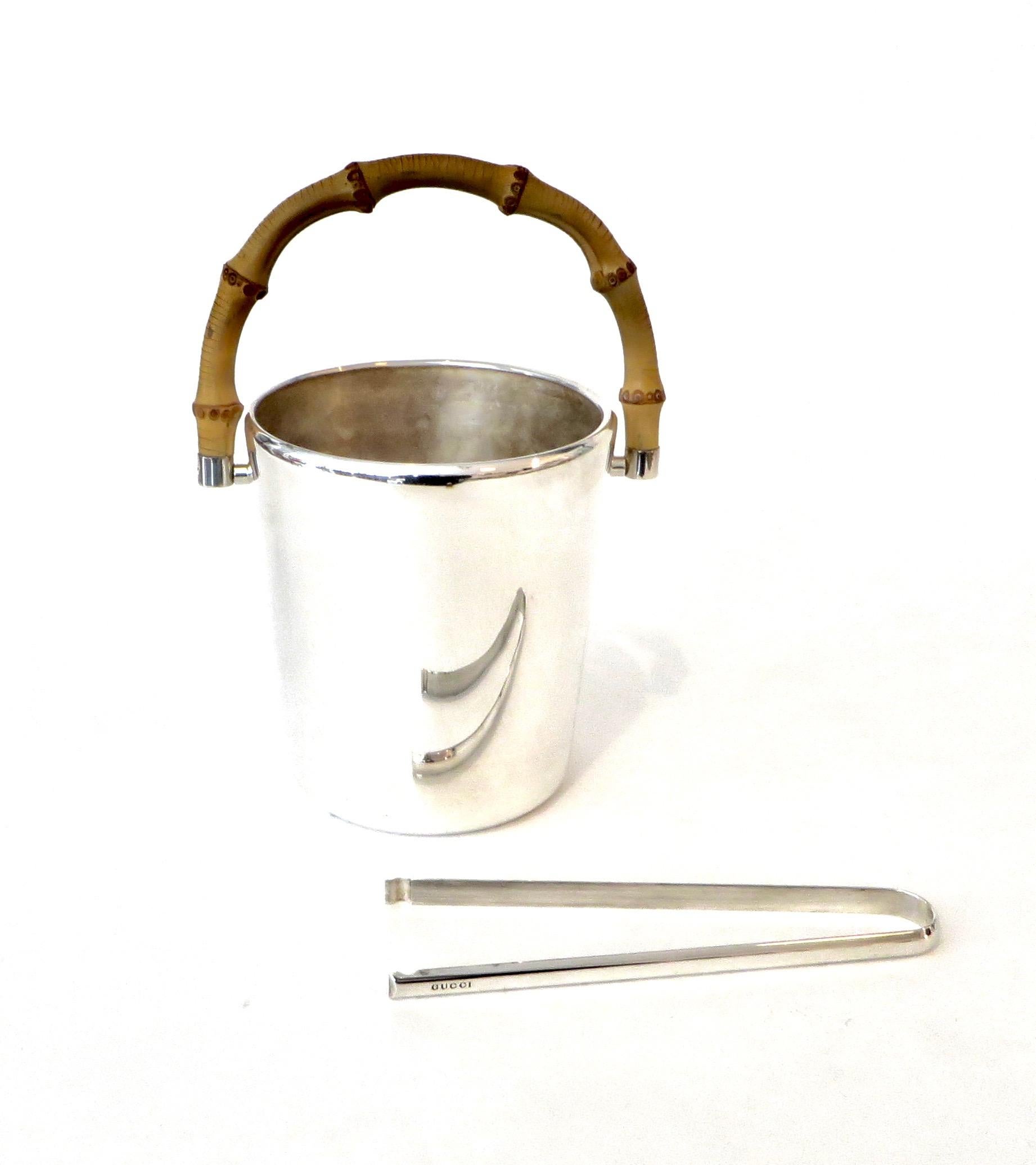 A silver plate with bamboo handle Gucci made in Italy ice bucket with ice tongs.
Both ice bucket and ice tongs stamped Gucci. The ice bucket is also stamped Made in Italy.
Excellent condition with no scratches on the bucket. The bottom does show