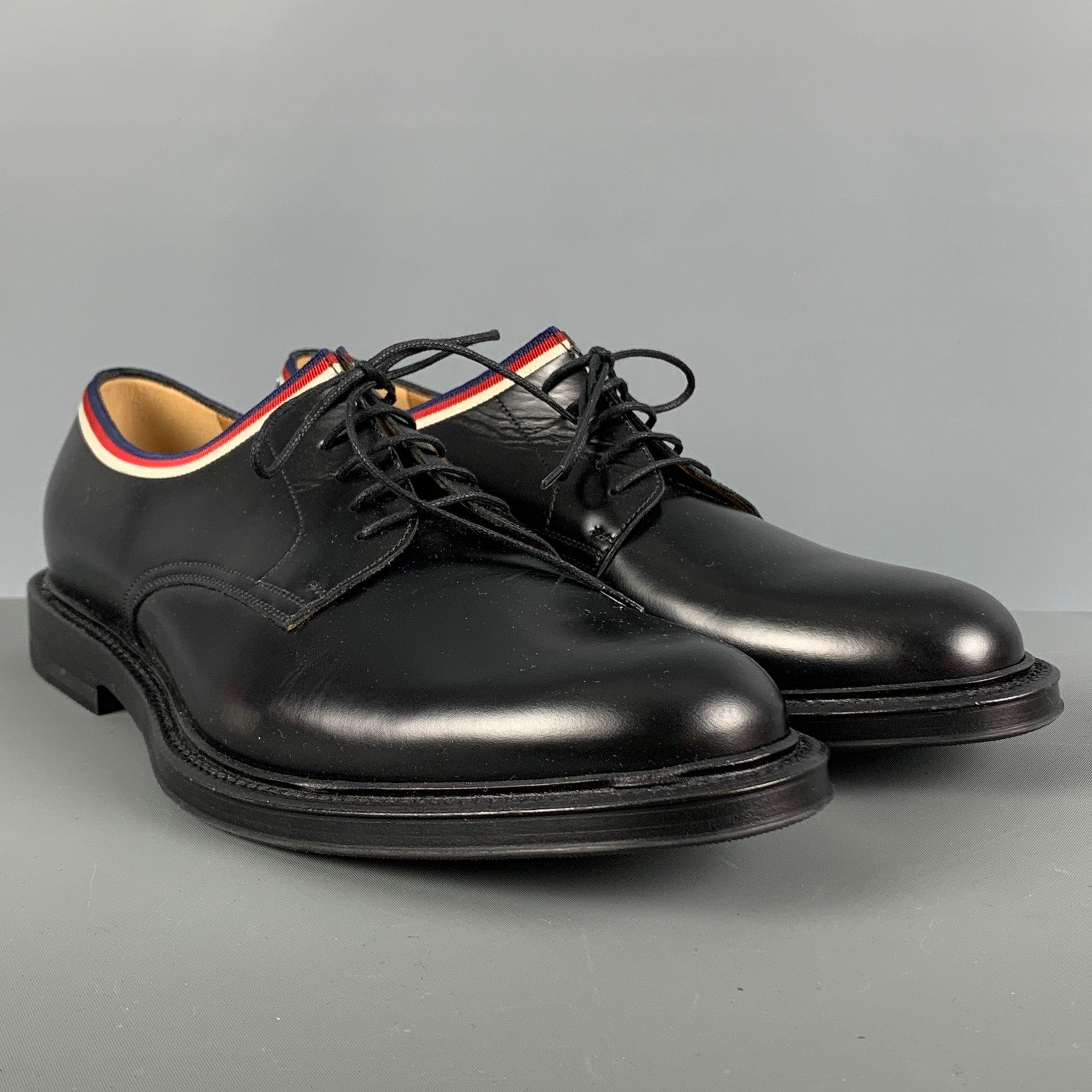 GUCCI shoes comes in a black leather featuring a derby style, blue, red and white ribbon detail, and a lace up closure. Made in Italy.Excellent Pre-Owned Condition. 

Marked:   472749 91/2 04JOutsole: 12.5 inches  x 4.75 inches 
  
  
 
Reference: