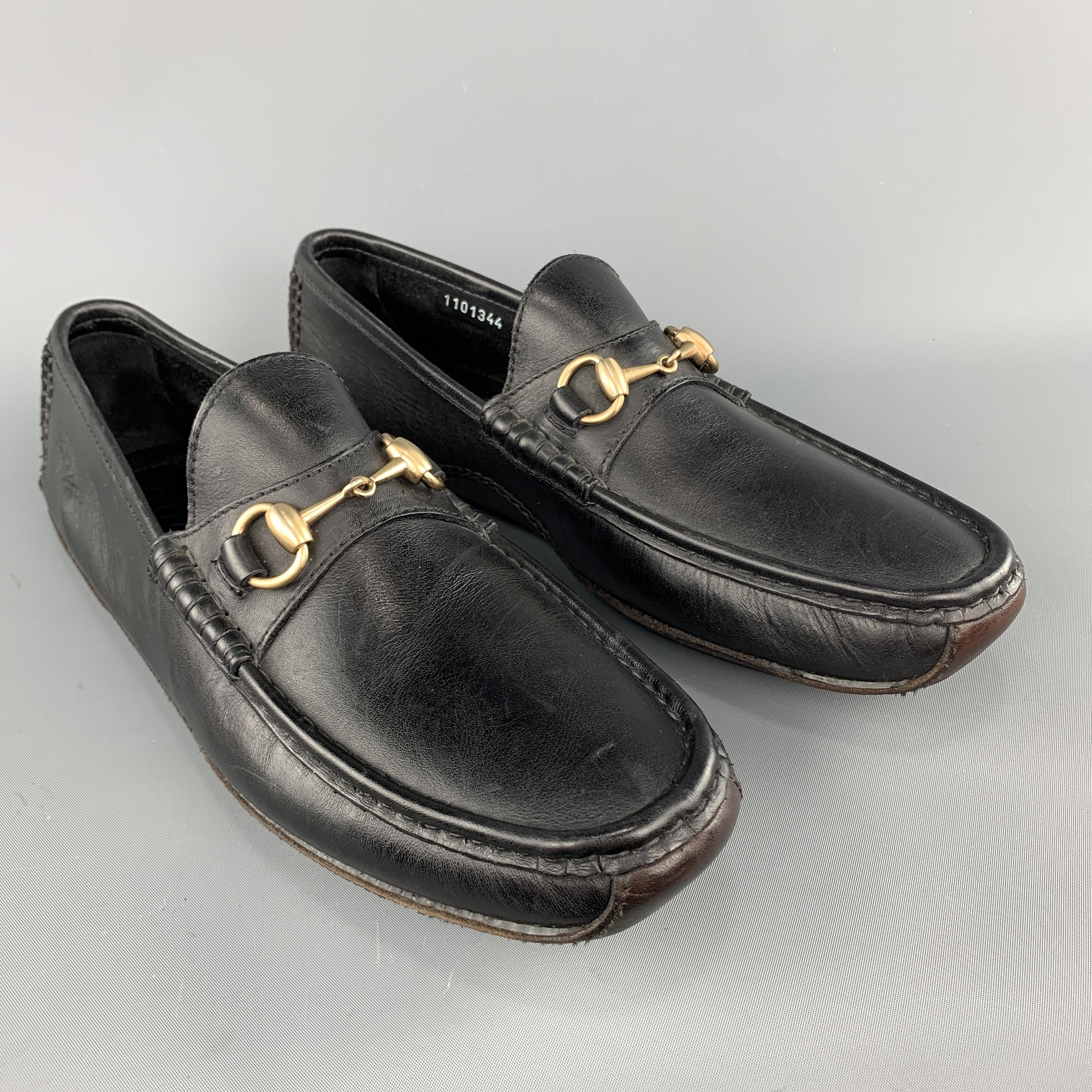 Gucci penny loafers come in black leather with an apron toe, gold tone horsebit, and brown leather driver sole. Wear throughout. As-is. Made in Italy.

Good Pre-Owned Condition.
Marked: 10 M

Outsole: 11.25 x 3.75 in.