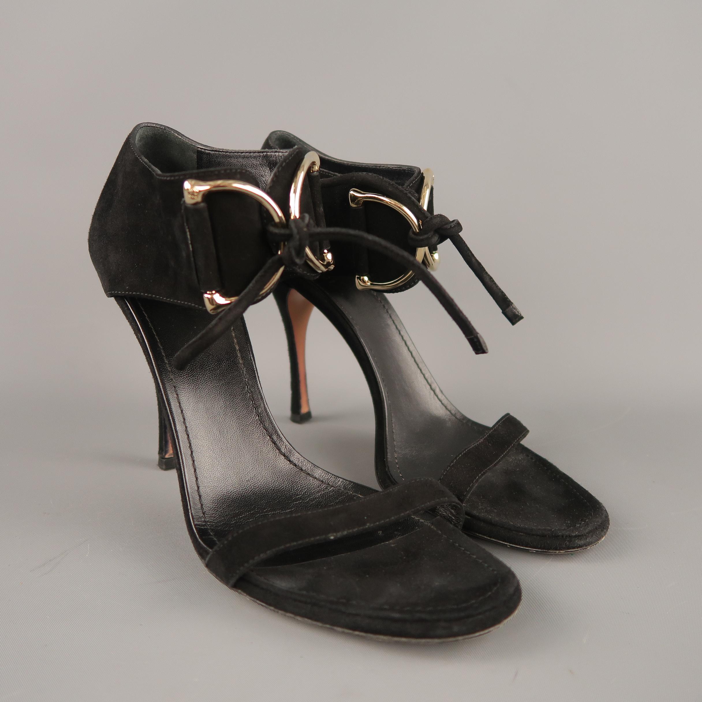 GUCCI sandals come in black suede with a thin toe strap, covered stiletto heel, and thick ankle strap, detailed with oversized, embossed D loops with tie closure. With dust bag. Made in Italy.
 
Very Good Pre-Owned Condition.
Marked: UK 9B
