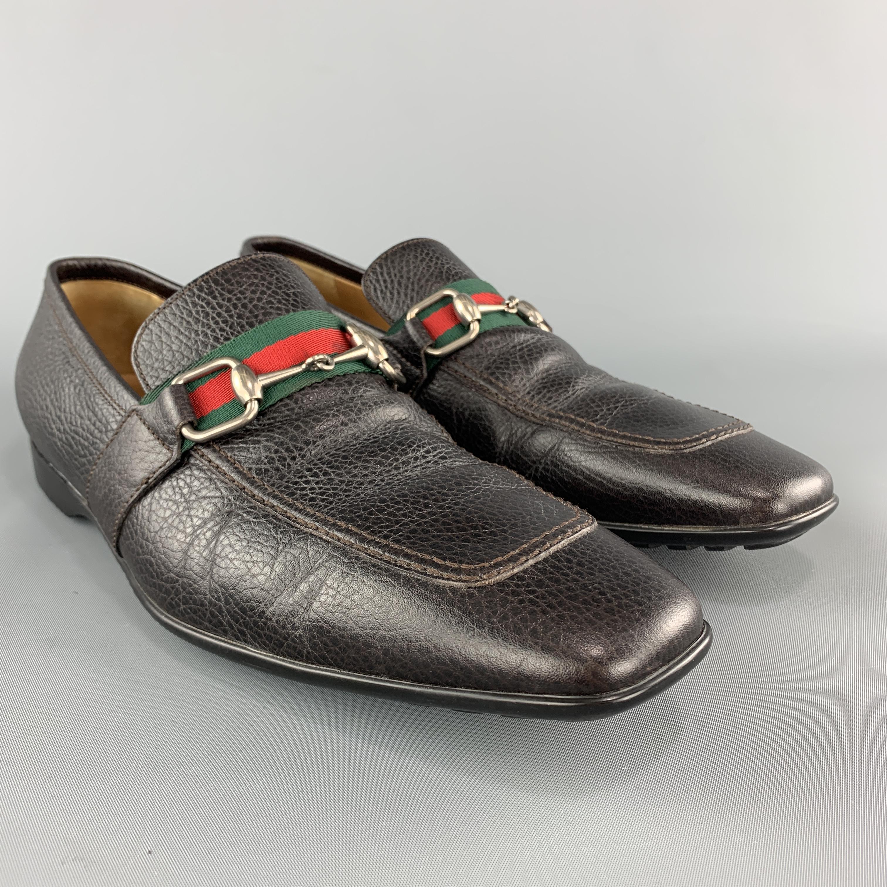 GUCCI slip on loafers come in dark brown textured leather with a rubber sole and squared apron toe detailed with a striped band and silver tone horsebit. Made in Italy.

Very Good Pre-Owned Condition.
Marked: IT 43

Outsole: 12 x 4 in.