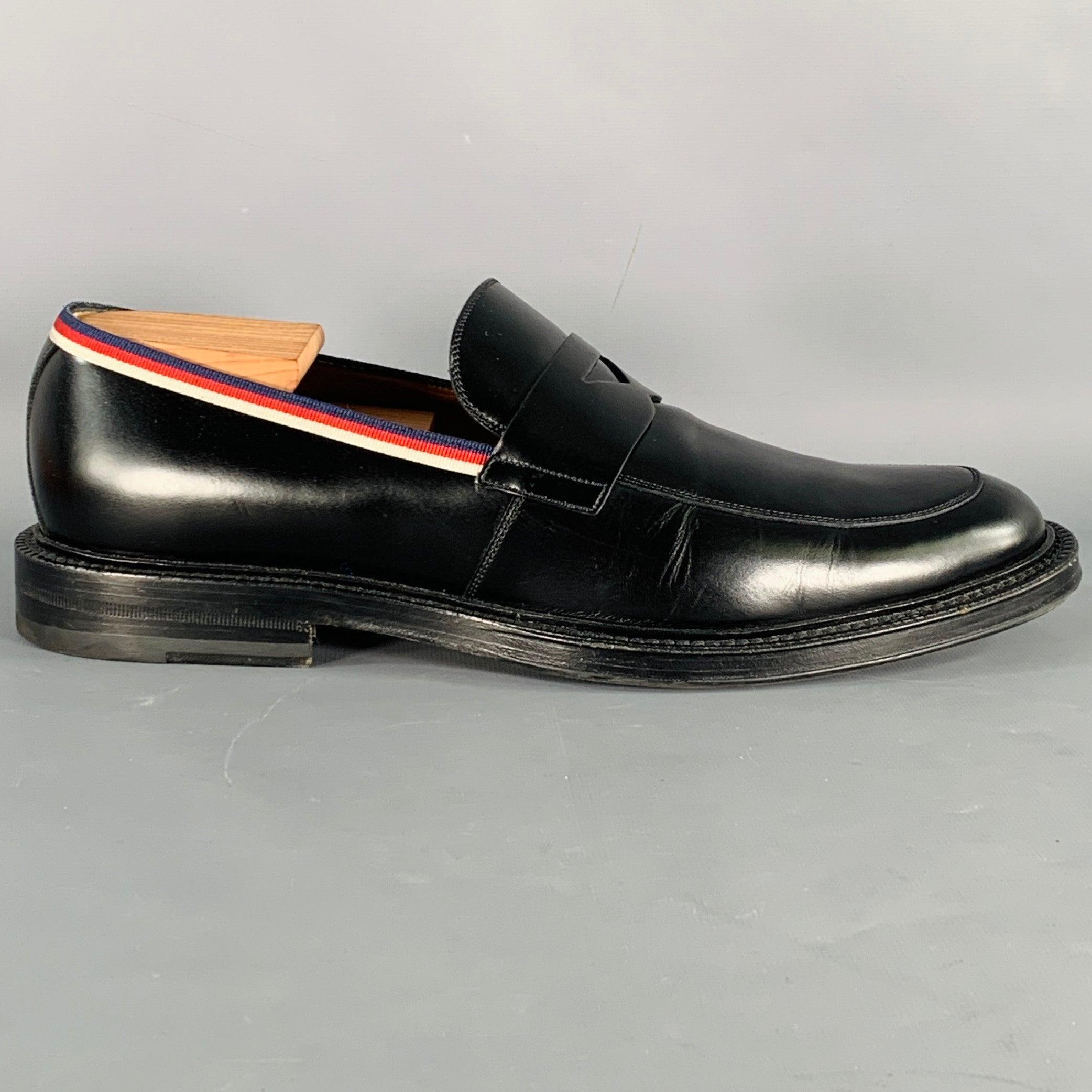 GUCCI loafers
in a black leather featuring a penny style, signature striped contrast trim, and slip on closure. Shoe trees not included. Made in Italy.Excellent Pre-Owned Condition. 

Marked:   UK 10Outsole: 12.5 inches  x 4.5 inches  
  
  
 
Sui