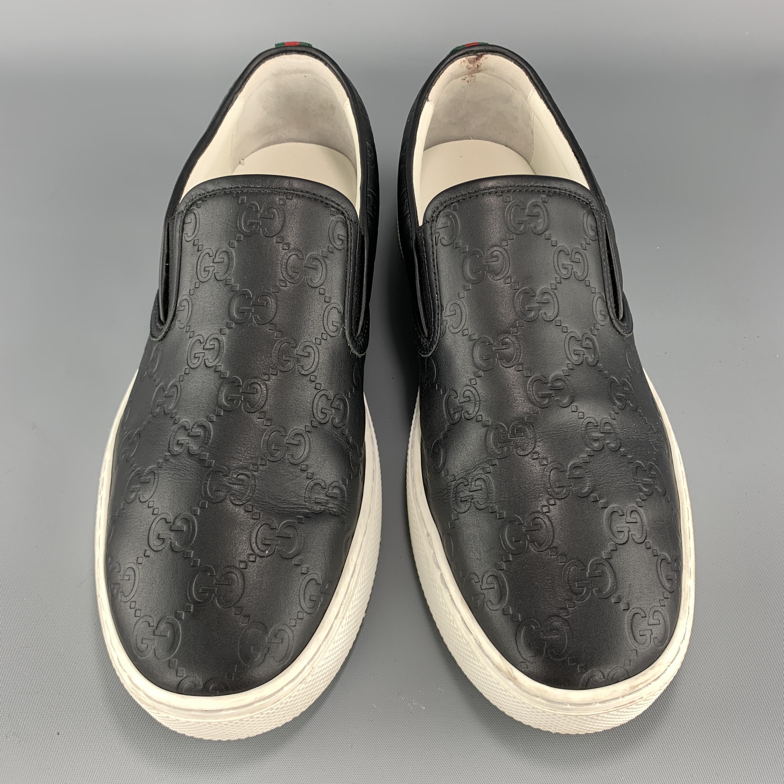 GUCCI slip on sneakers come in black Guccissima monogram embossed leather with a white rubber sole and signature stripe webbing back detail. Made in Italy.

Excellent Pre-Owned Condition.
Marked: UK 9.5

Outsole: 11.75 x 4.25 in. 