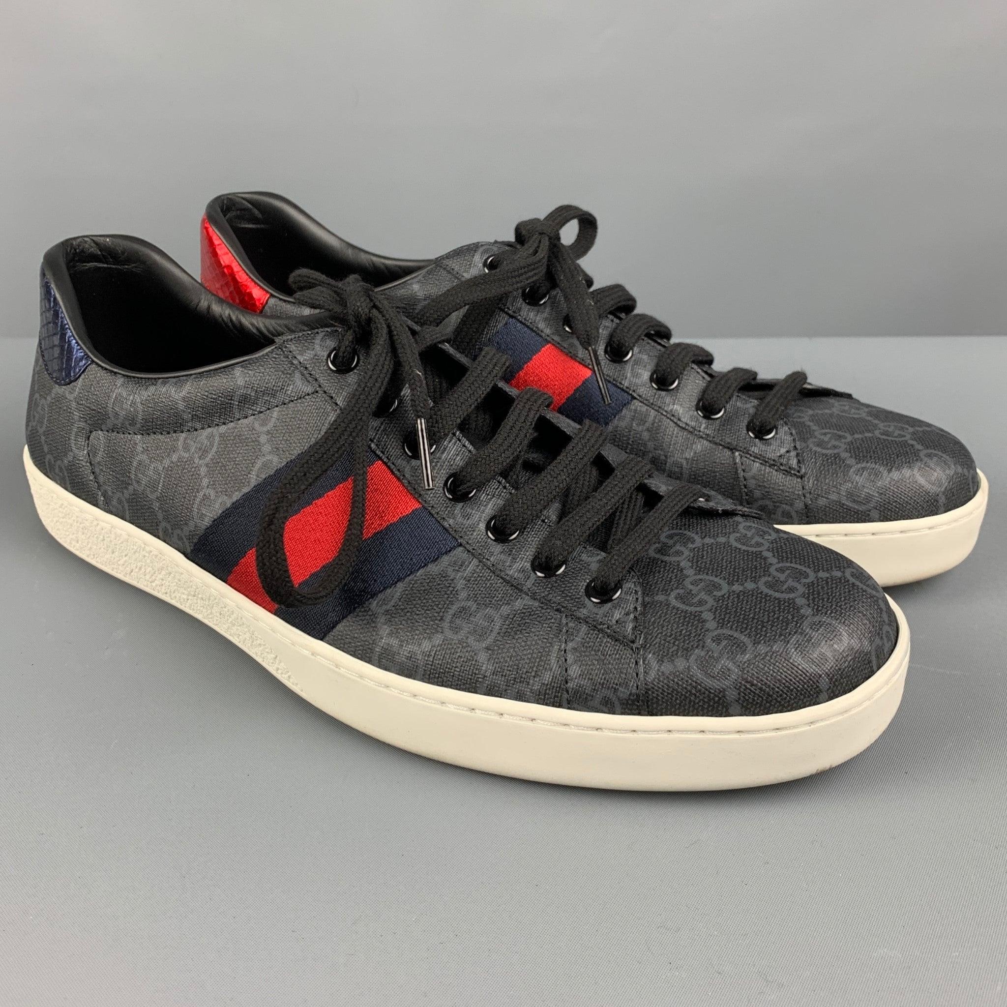 GUCCI sneakers
in a black leather featuring signature grey monogram pattern, red and blue color block stripes, contrast scale pattern heels, and lace up closure. Made in Italy. Very Good Pre-Owned Condition. Minor signs of wear. 

Marked:   429 443