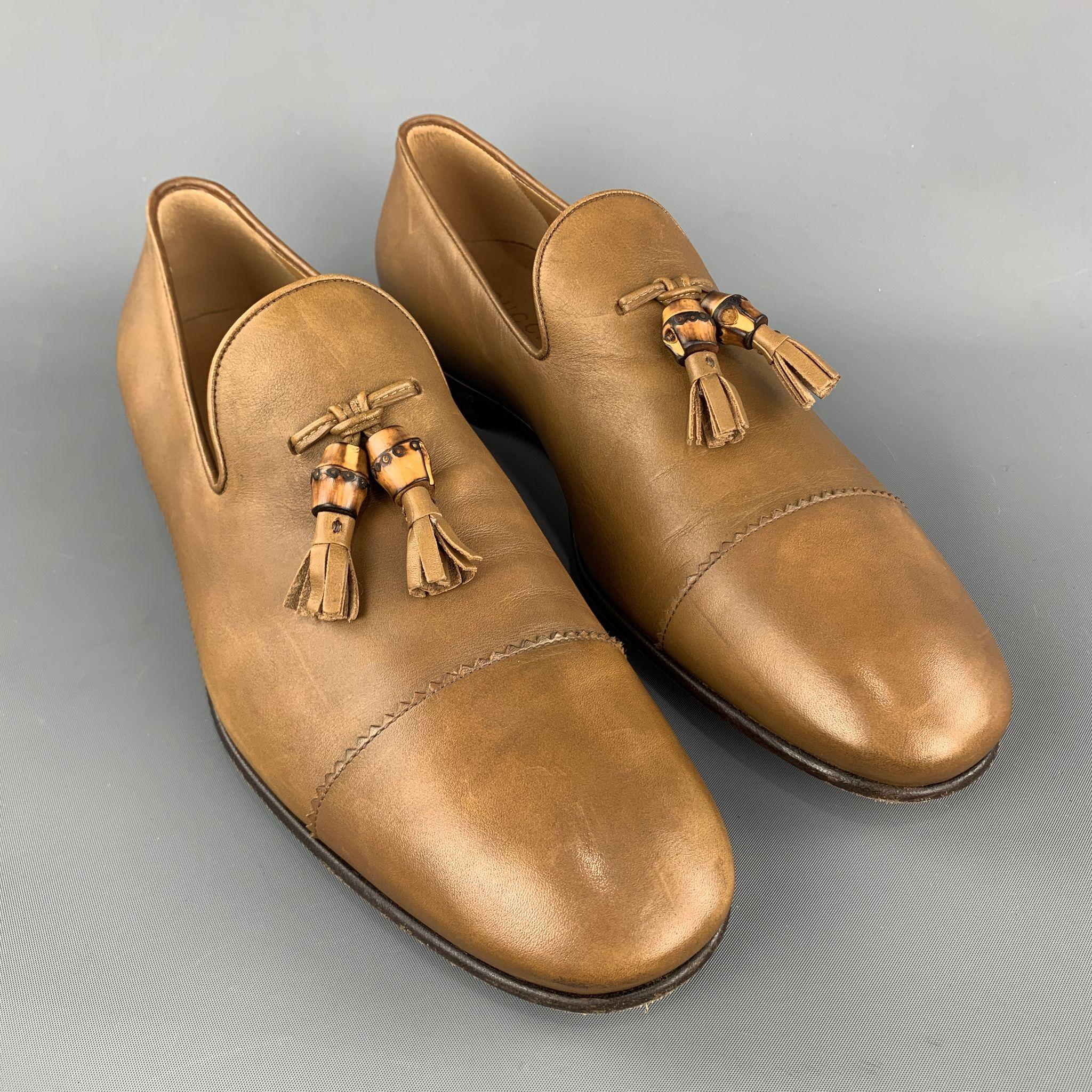 GUCCI loafers comes in a tan leather featuring a slip on style, front tassel details, and wooden sole. Made in Italy.

 

Excellent Pre-Owned Condition.
Marked: 10

Outsole: 4 in. x 12 in. 